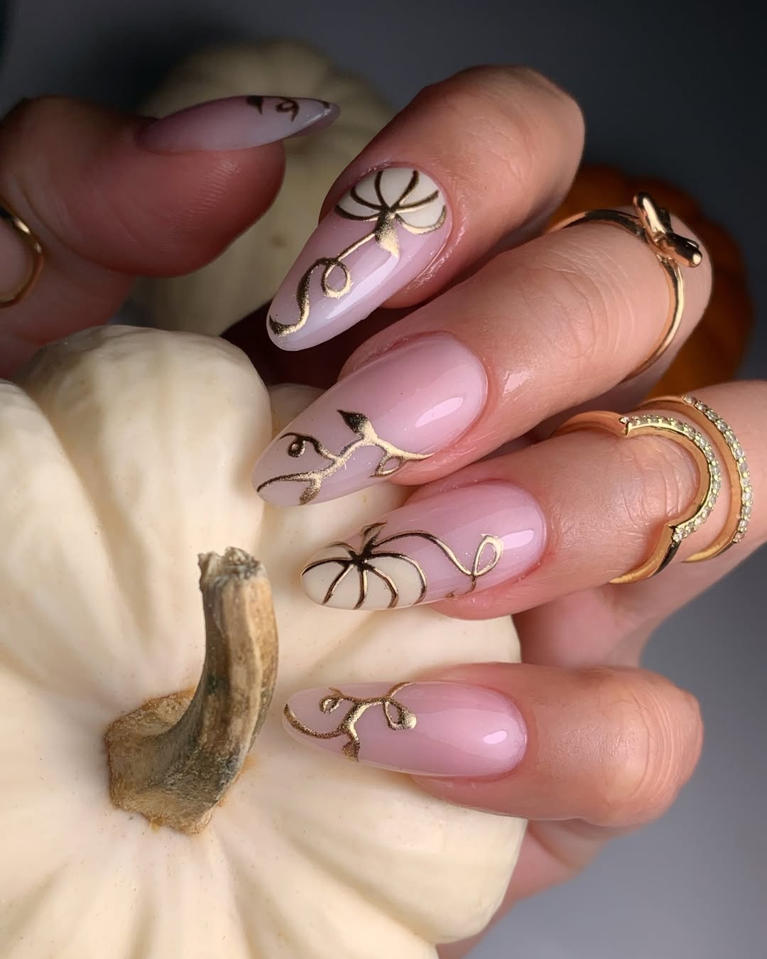 Soft Pink Almond Nails with Gold Pumpkin Art