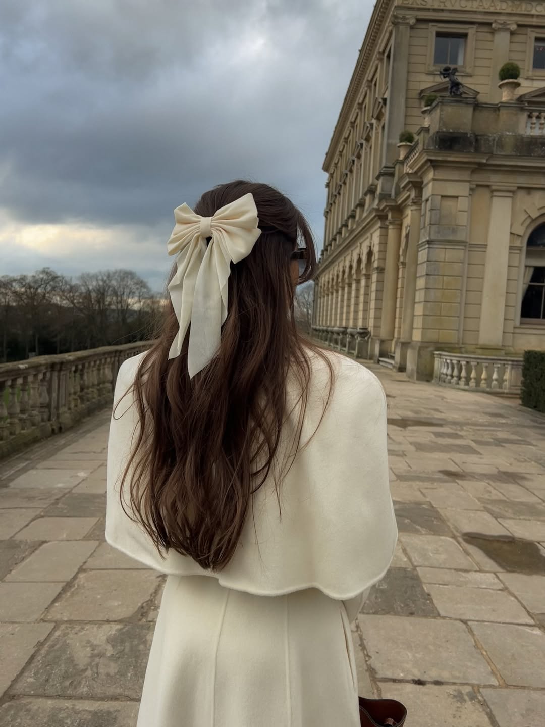 Sophisticated Half-Up Hairstyle With Oversized Bow