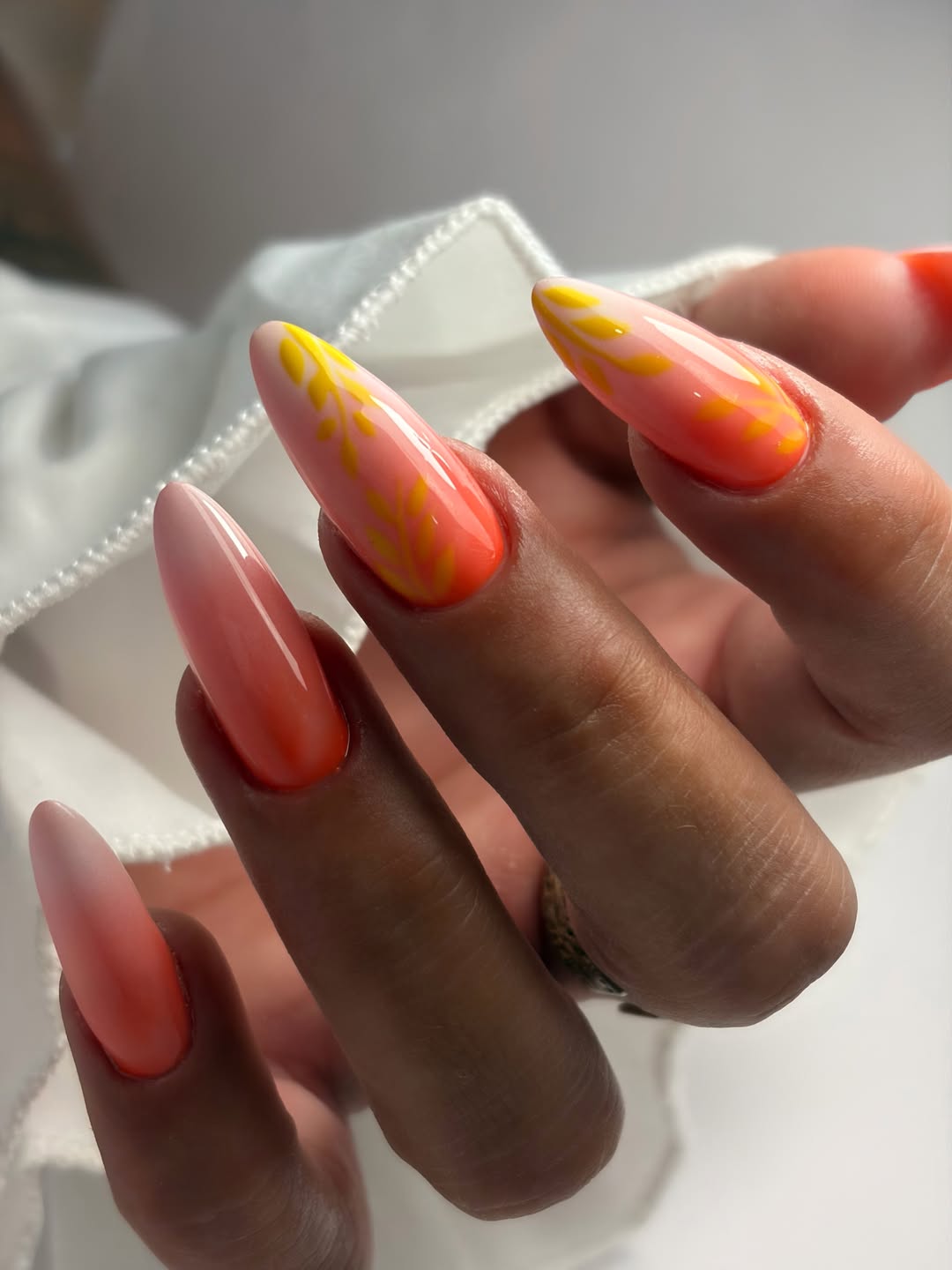Sunset Aura Stiletto Nails With Yellow Foliage