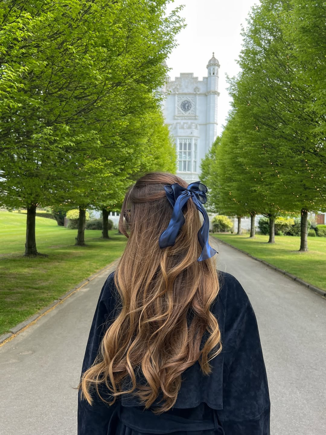 Textured Brunette Balayage Half-Up With Navy Bow