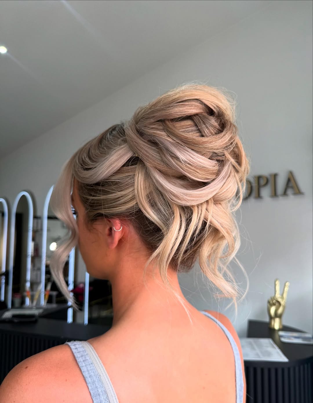 Textured High Messy Bun With Face-Framing Waves