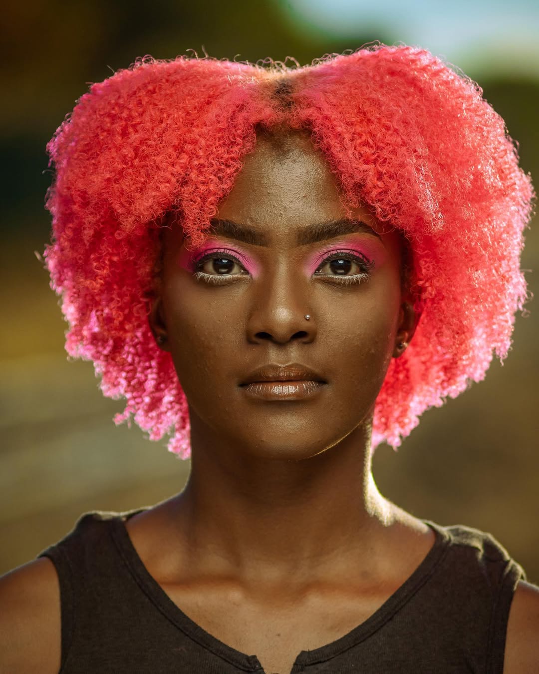 Vibrant Neon Pink Coily Pixie Cut