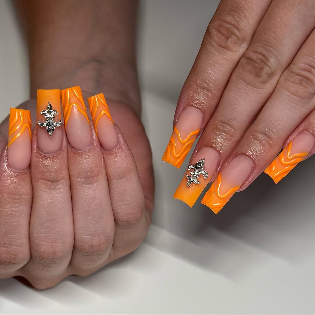 Vibrant Orange Swirl French Tips with Crystal Charms