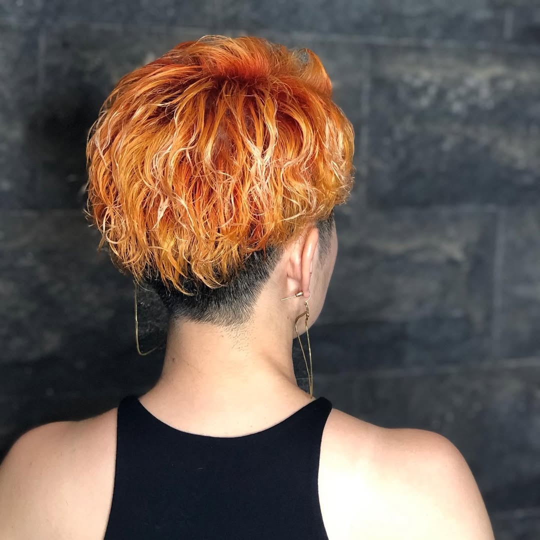 Vibrant Orange Wavy Undercut Pixie