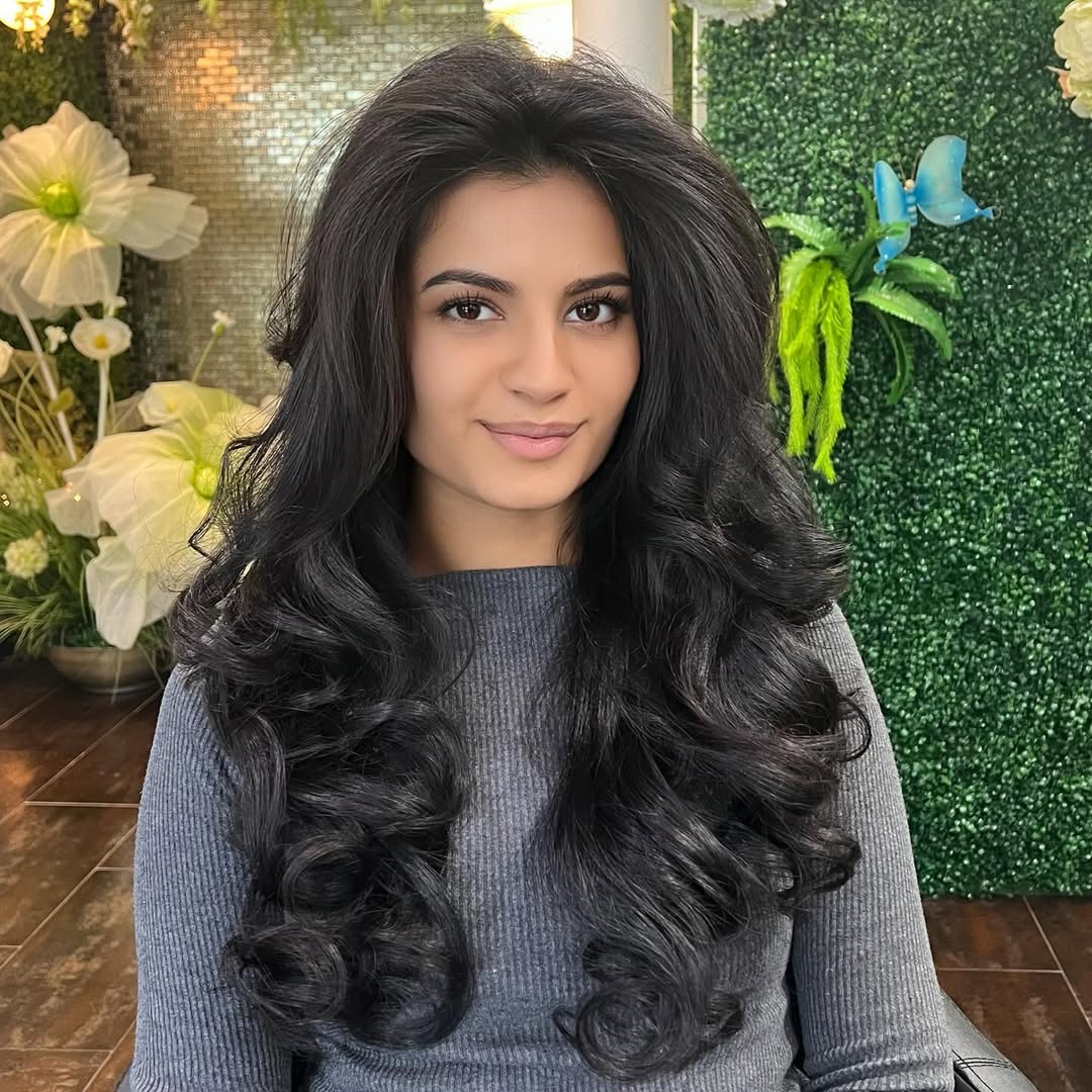 Voluminous Black Curls With Deep Side Part
