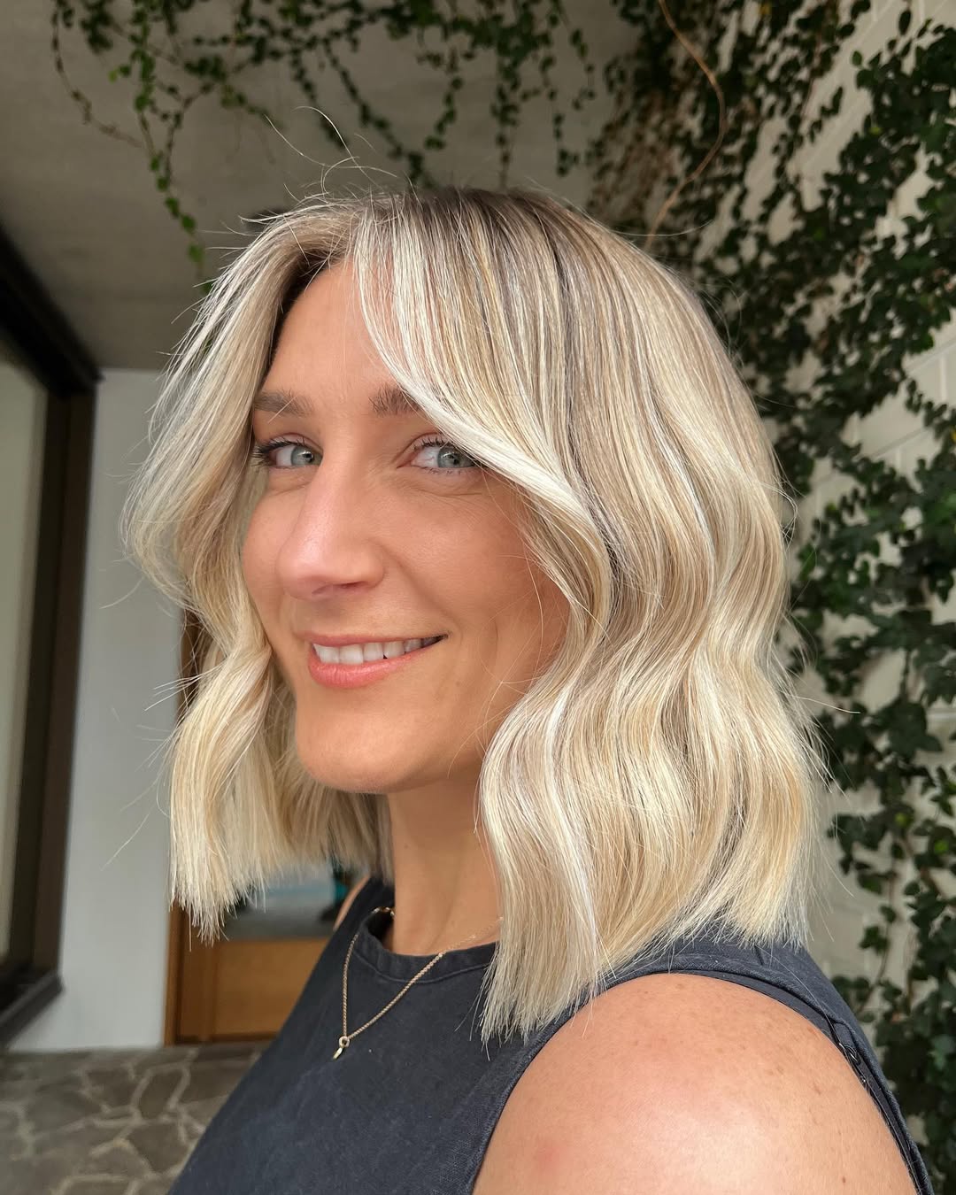 Wavy Shoulder-Length Blonde Lob With Shadow Root
