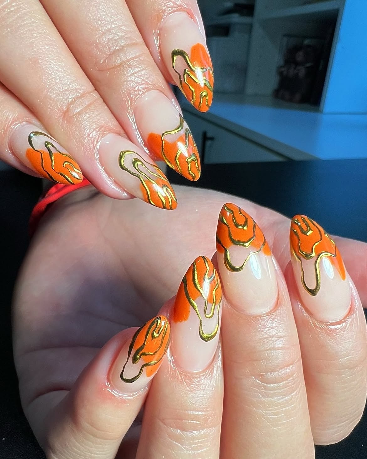 Abstract Orange and Gold Swirl Almond Nails