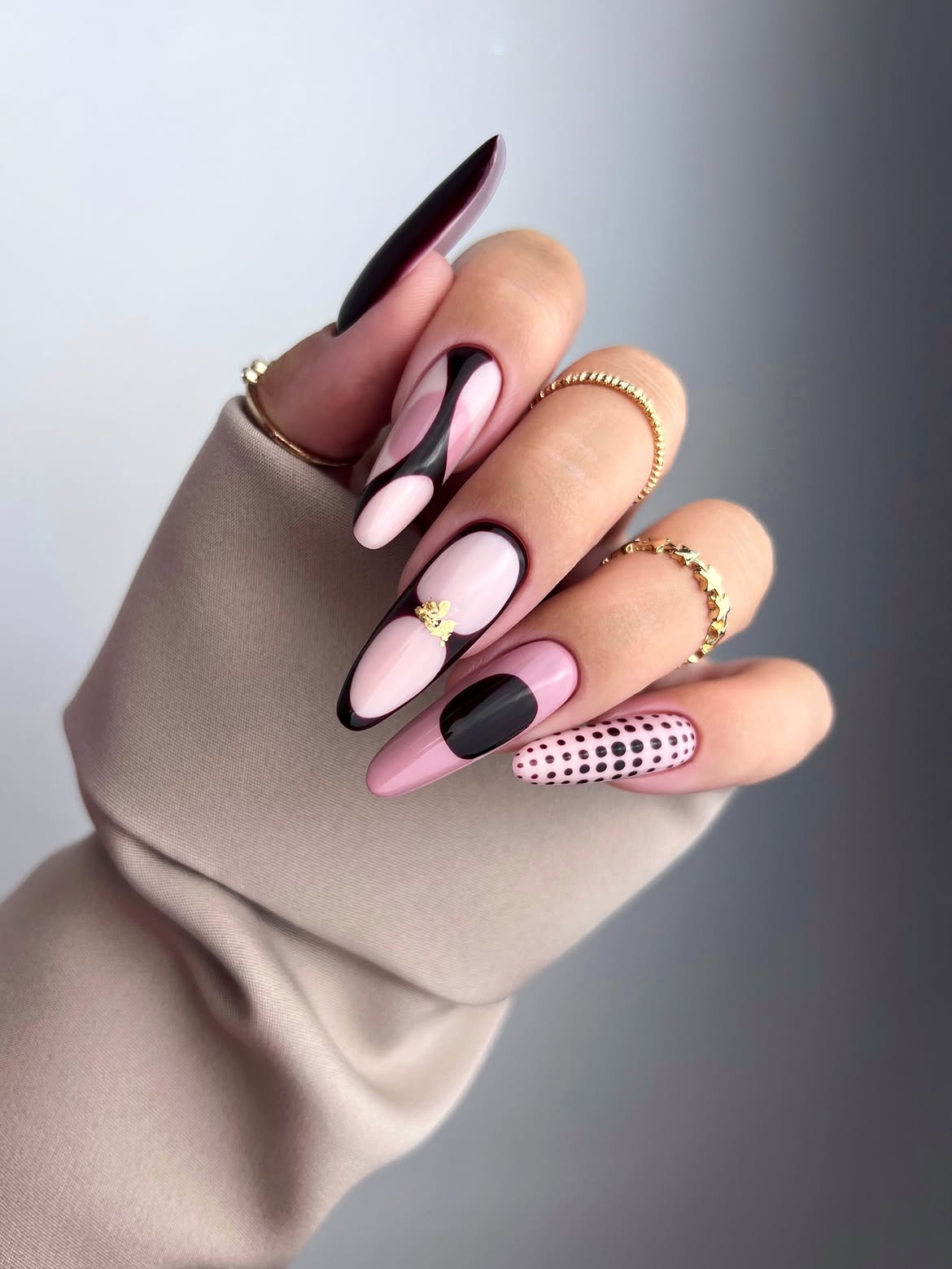 Abstract Pink and Black Stiletto Nails with Gold Accents