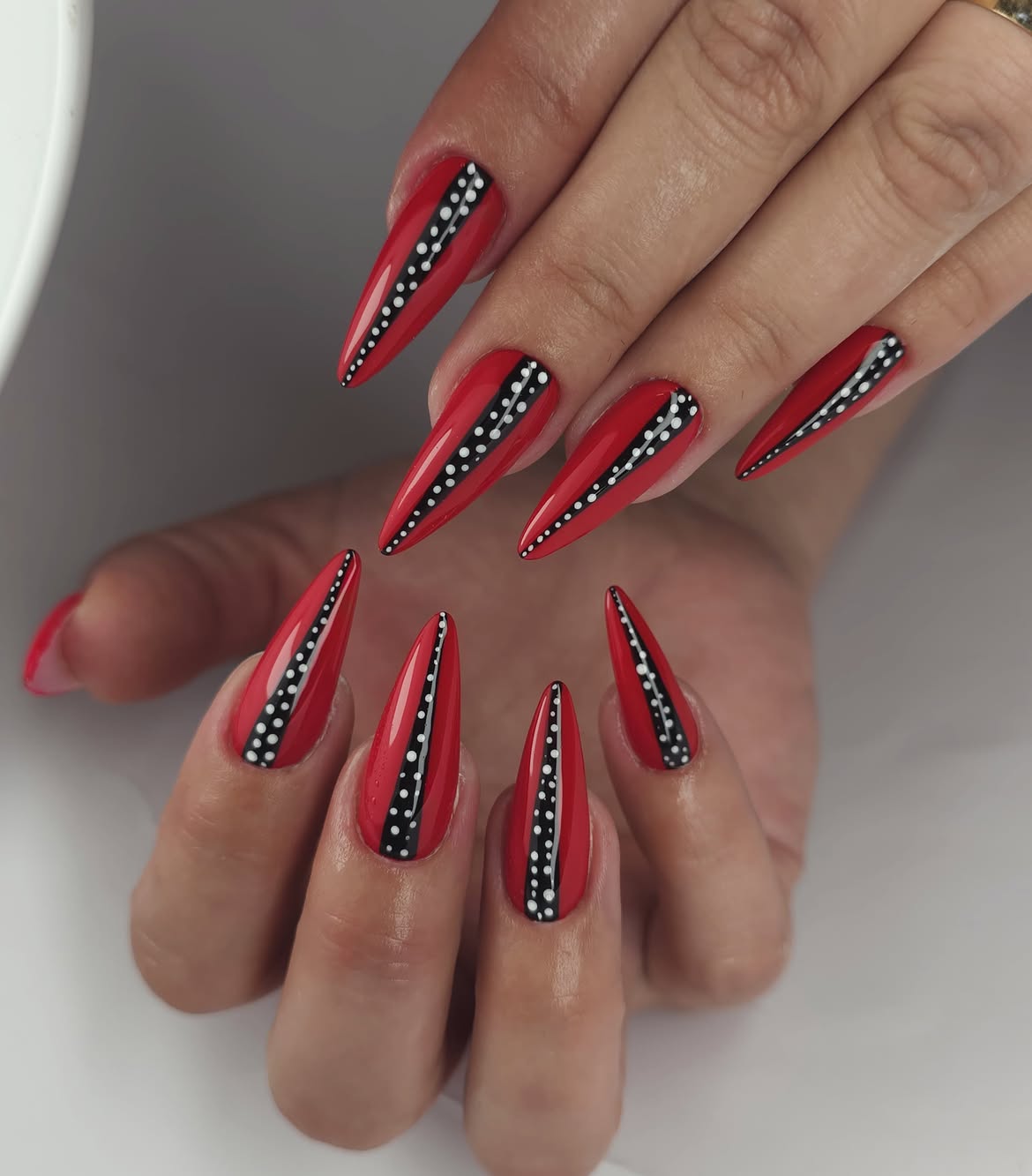 Bold Red Stiletto Nails With Black & White Dot Accents
