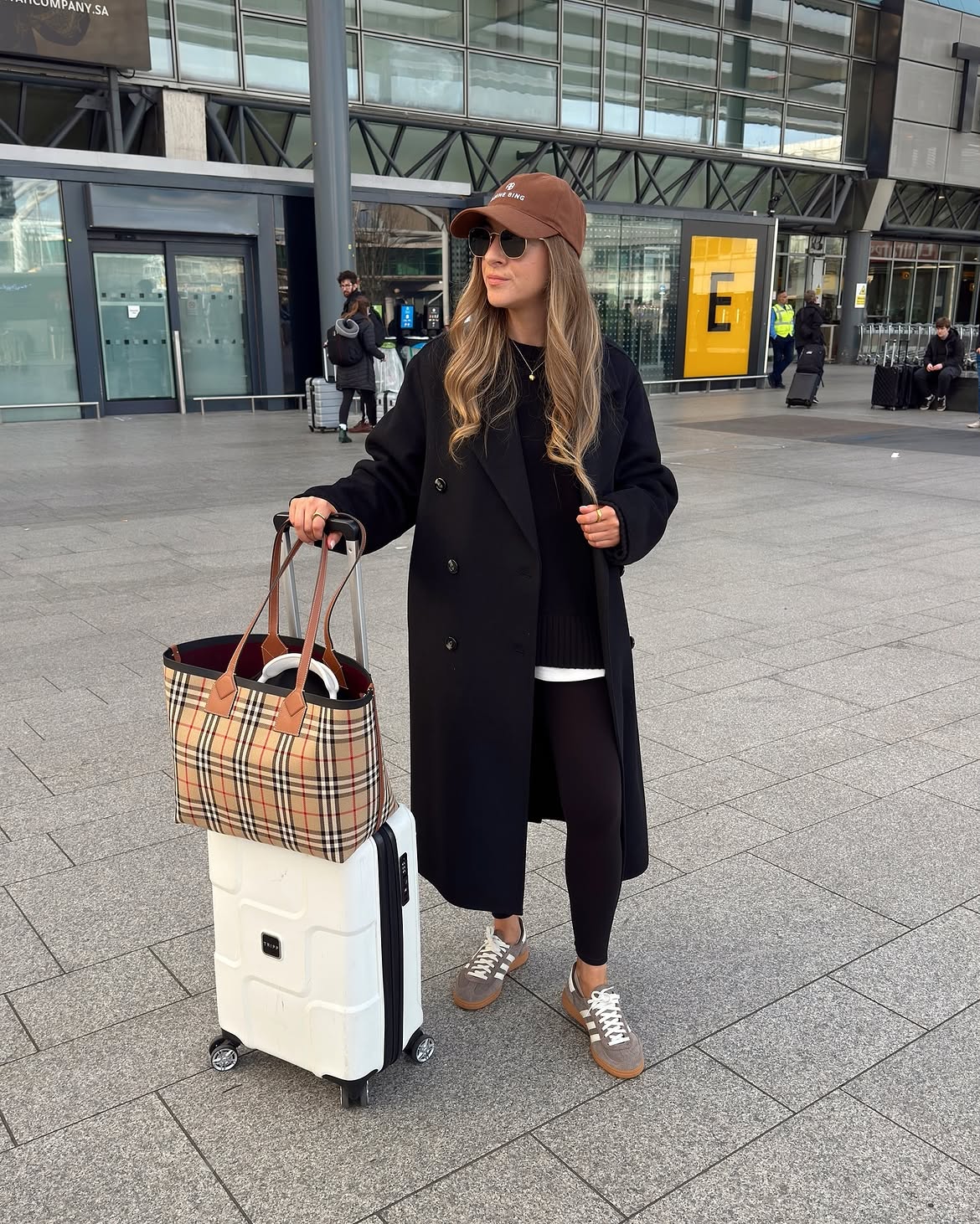 Chic Travel Look With Black Coat And Leggings