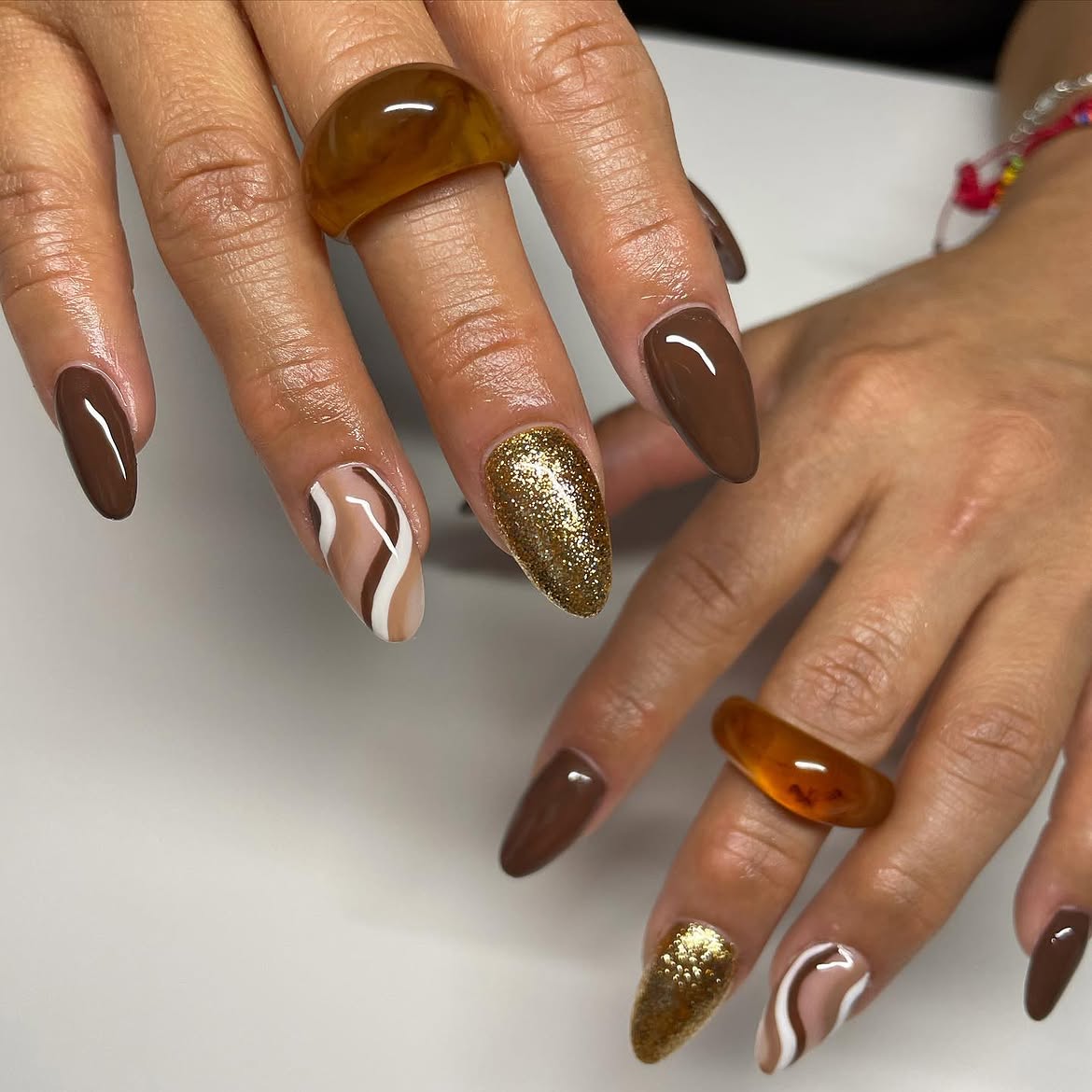 Chocolate Swirl and Gold Glitter Almond Nails
