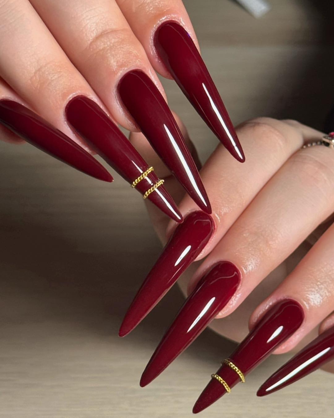 Deep Burgundy Stiletto Nails with Gold Wire Accent