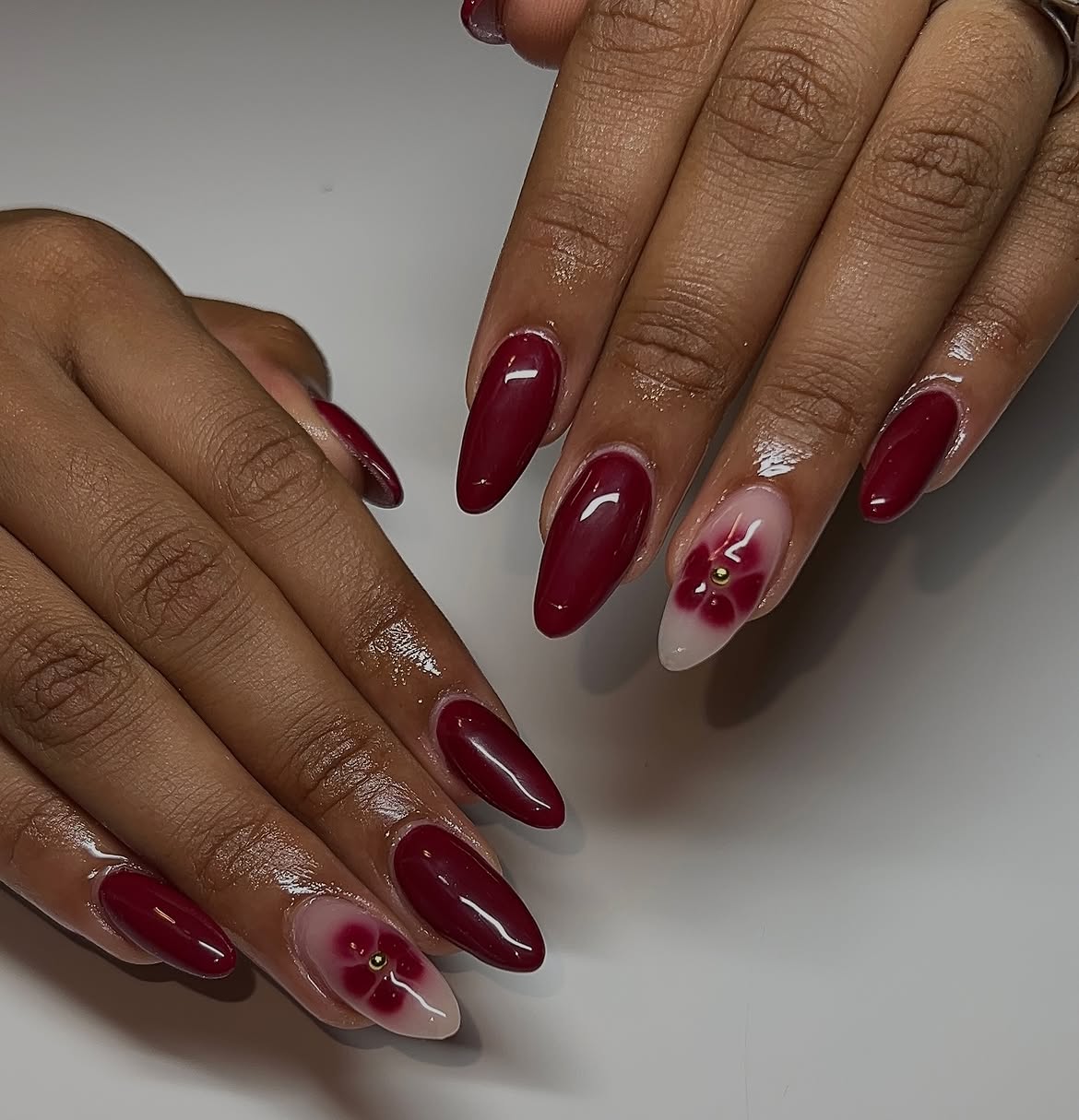 Deep Red Floral Almond Nails with Gold Accents