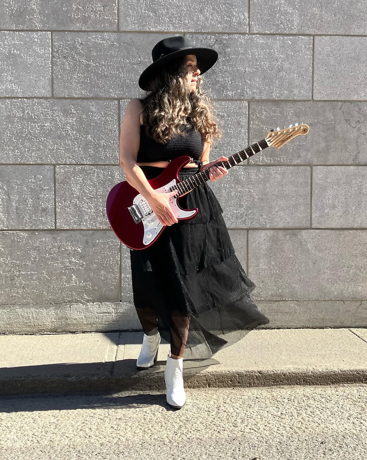 Edgy Black Festival Look With White Boots