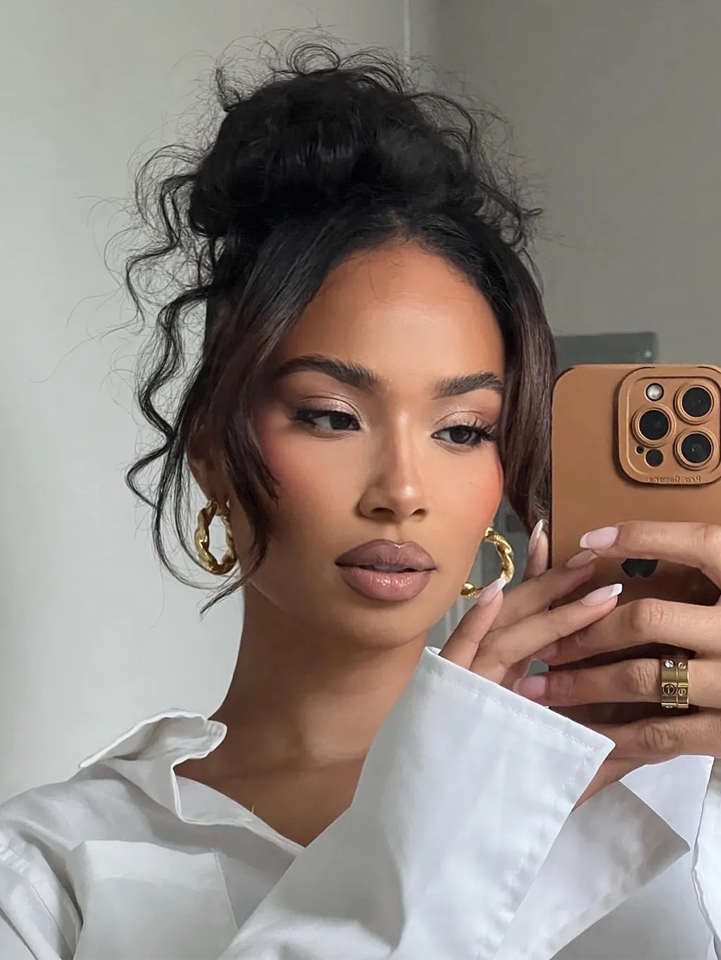 Effortless Messy Top Knot With Face-Framing Tendrils
