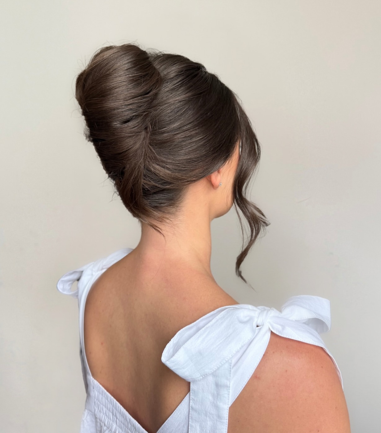 Elegant Sculpted Updo With Wispy Face-Framing Tendrils