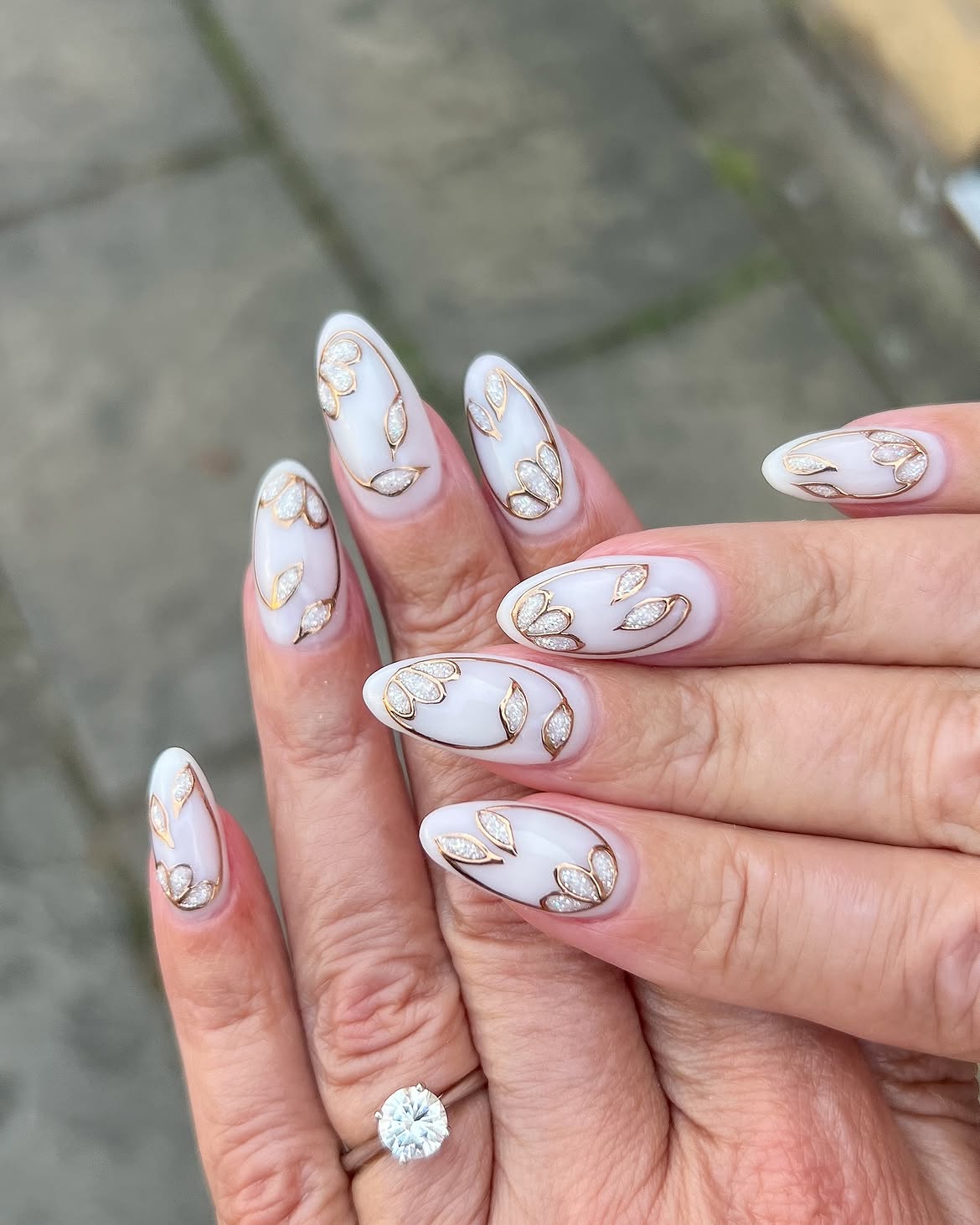 Elegant White and Gold Leaf Almond Nails