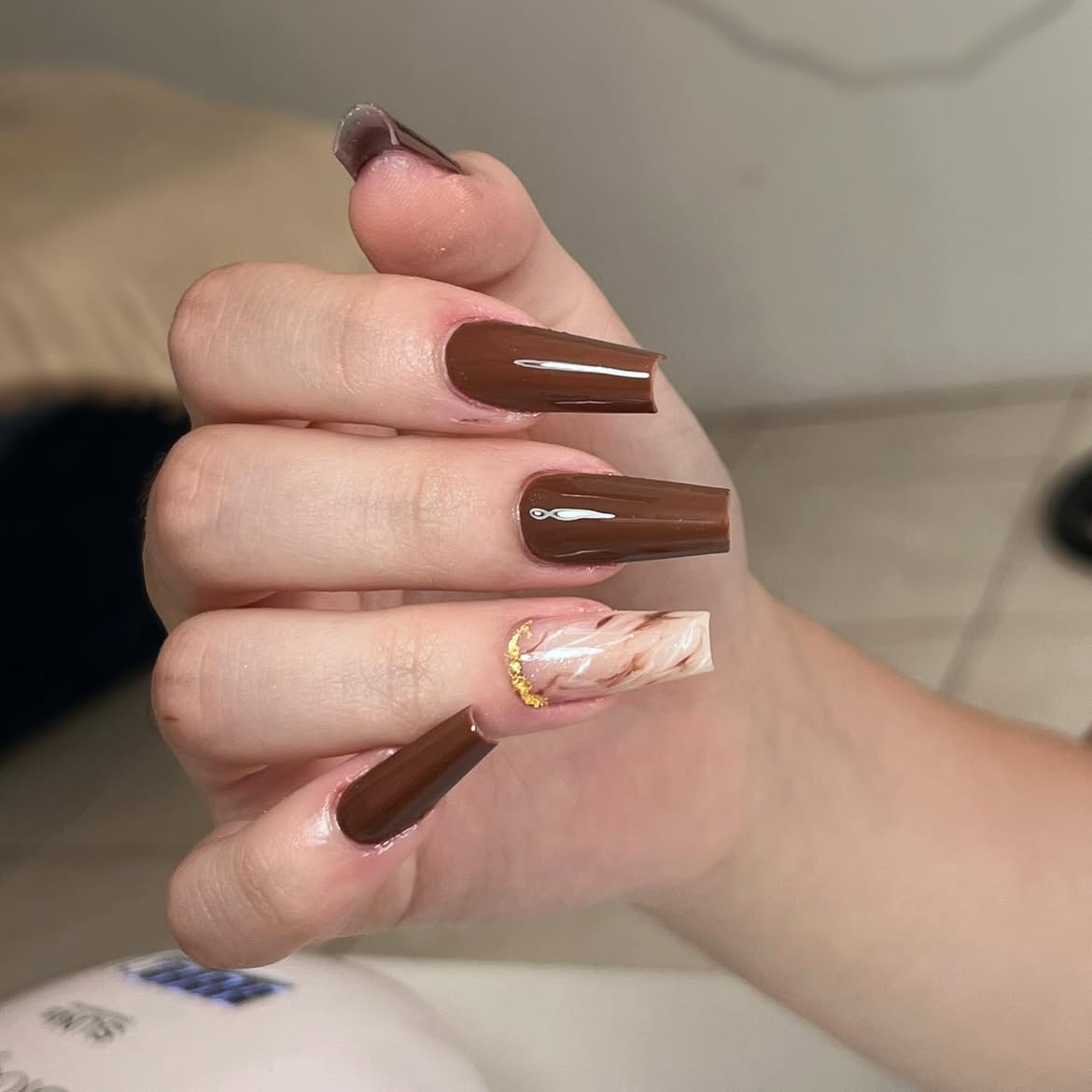 Glossy Chocolate Drip Coffin Nails with Marble Accent