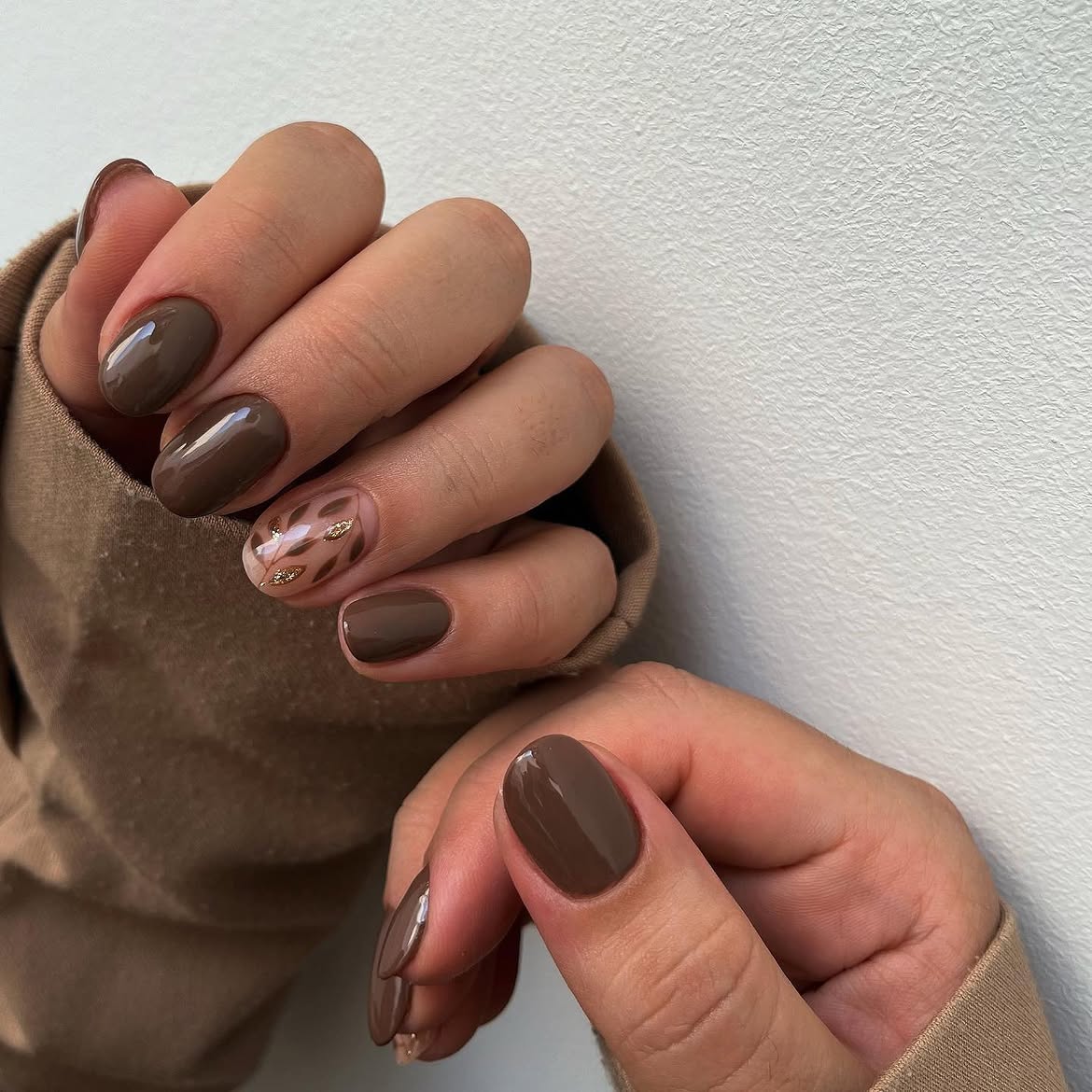 Glossy Mocha Brown Oval Nails with Gold Leaf Accents