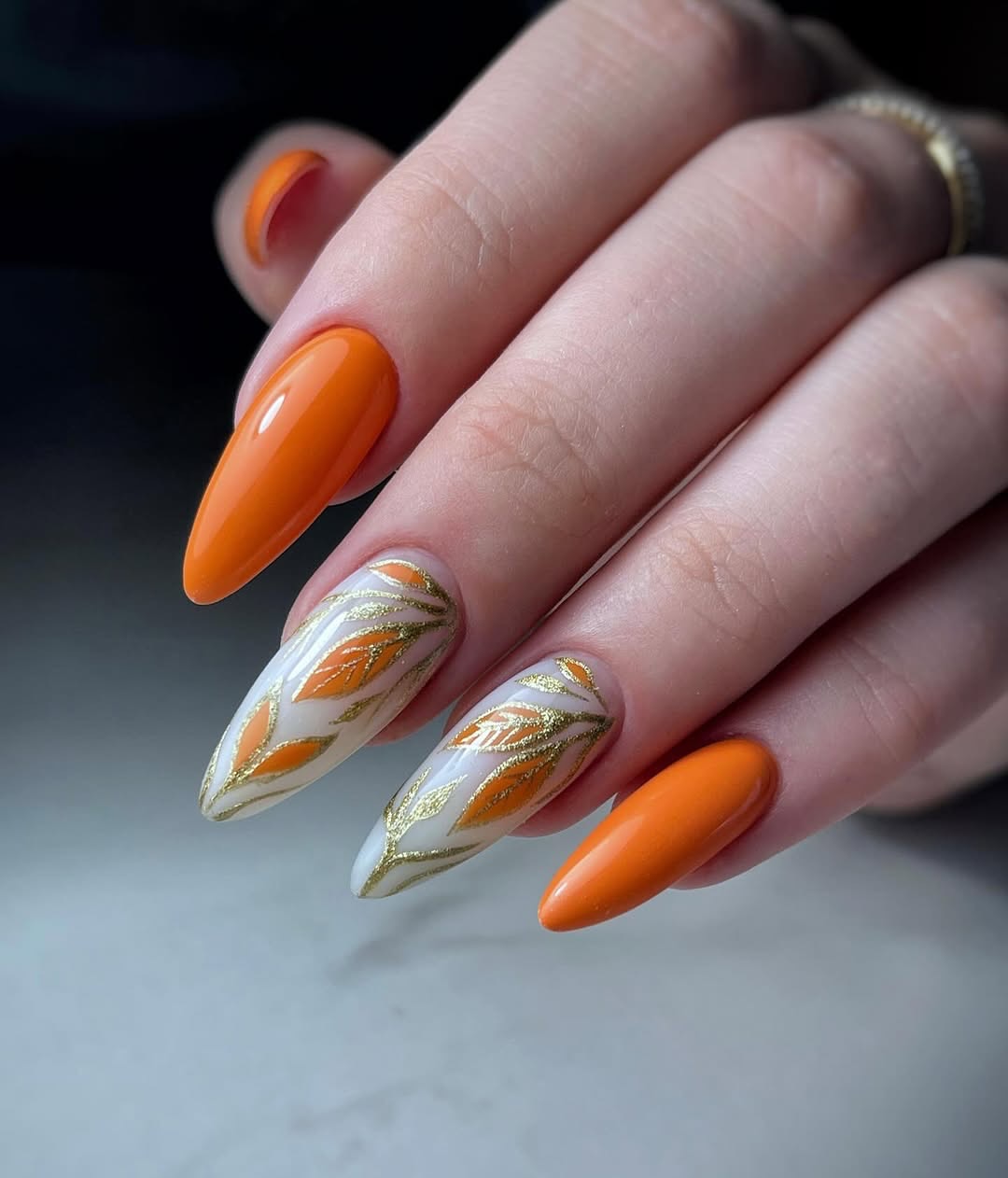 Glossy Orange Almond Nails with Gold Leaf Art