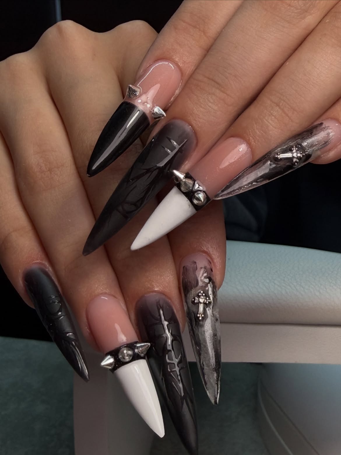 Gothic Stiletto Nails with Studded Accents and Cross Charms