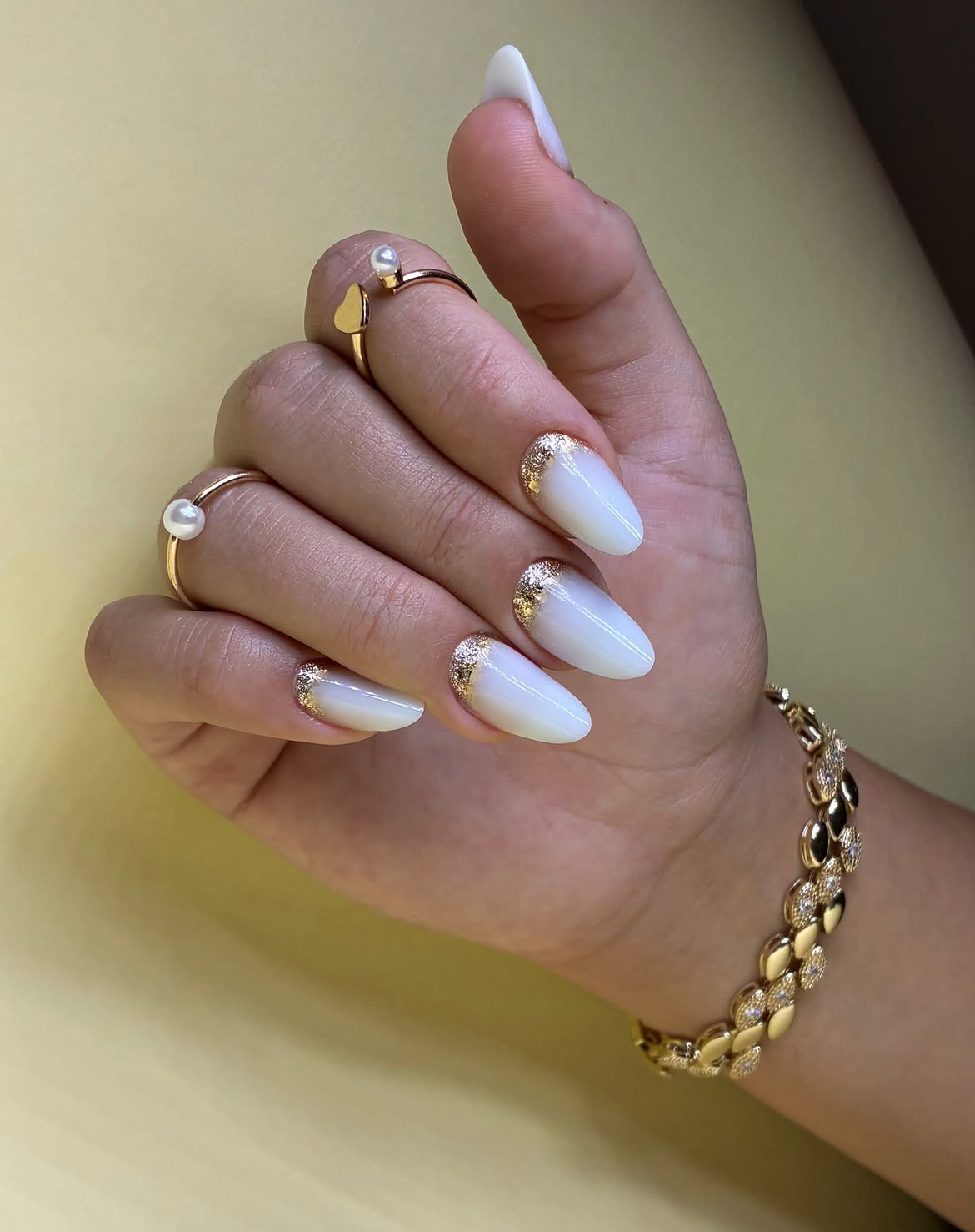 Milky White Almond Nails with Gold Glitter French Tips