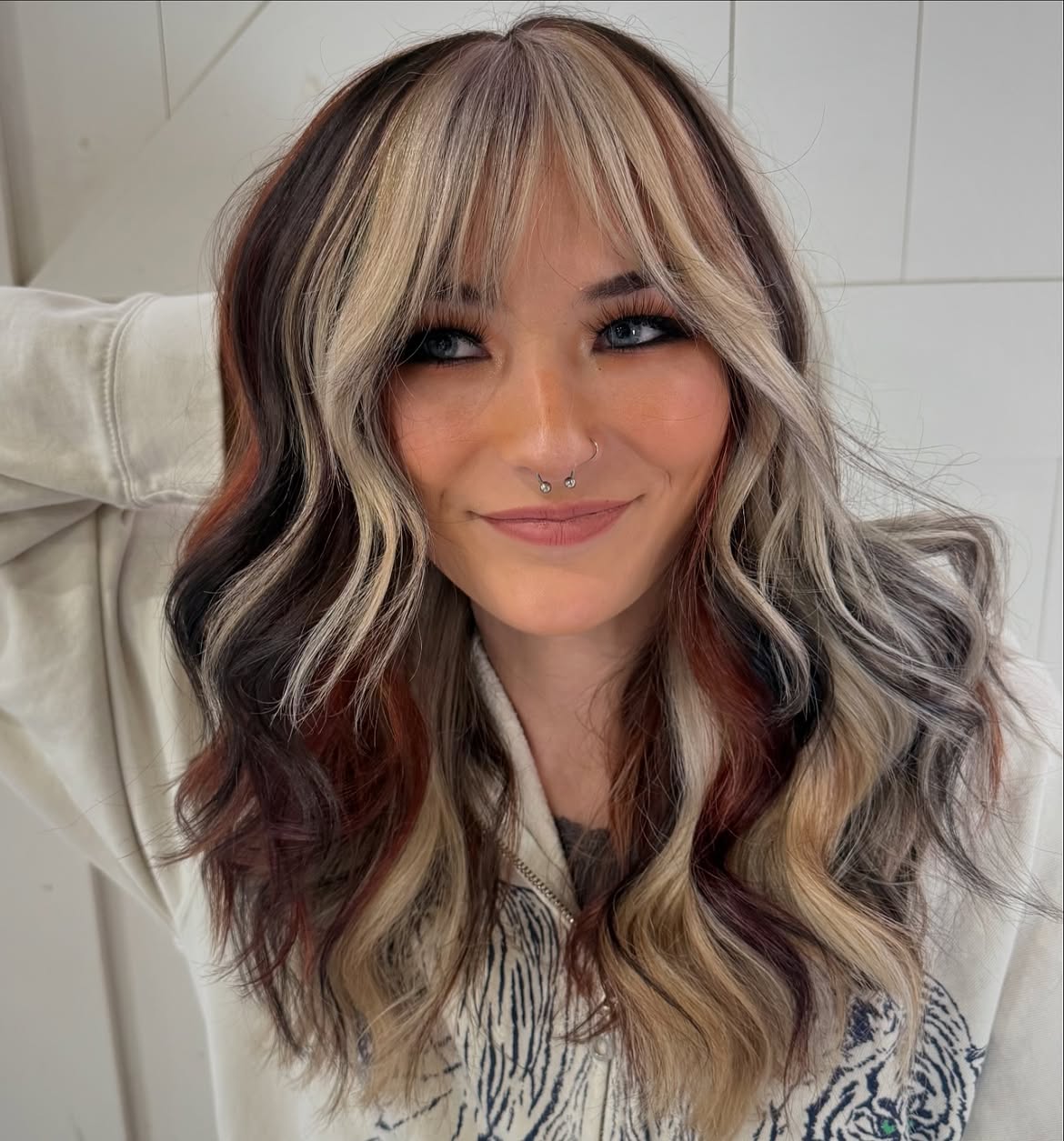 Multi-Tonal Curtain Bangs With Wavy Layers