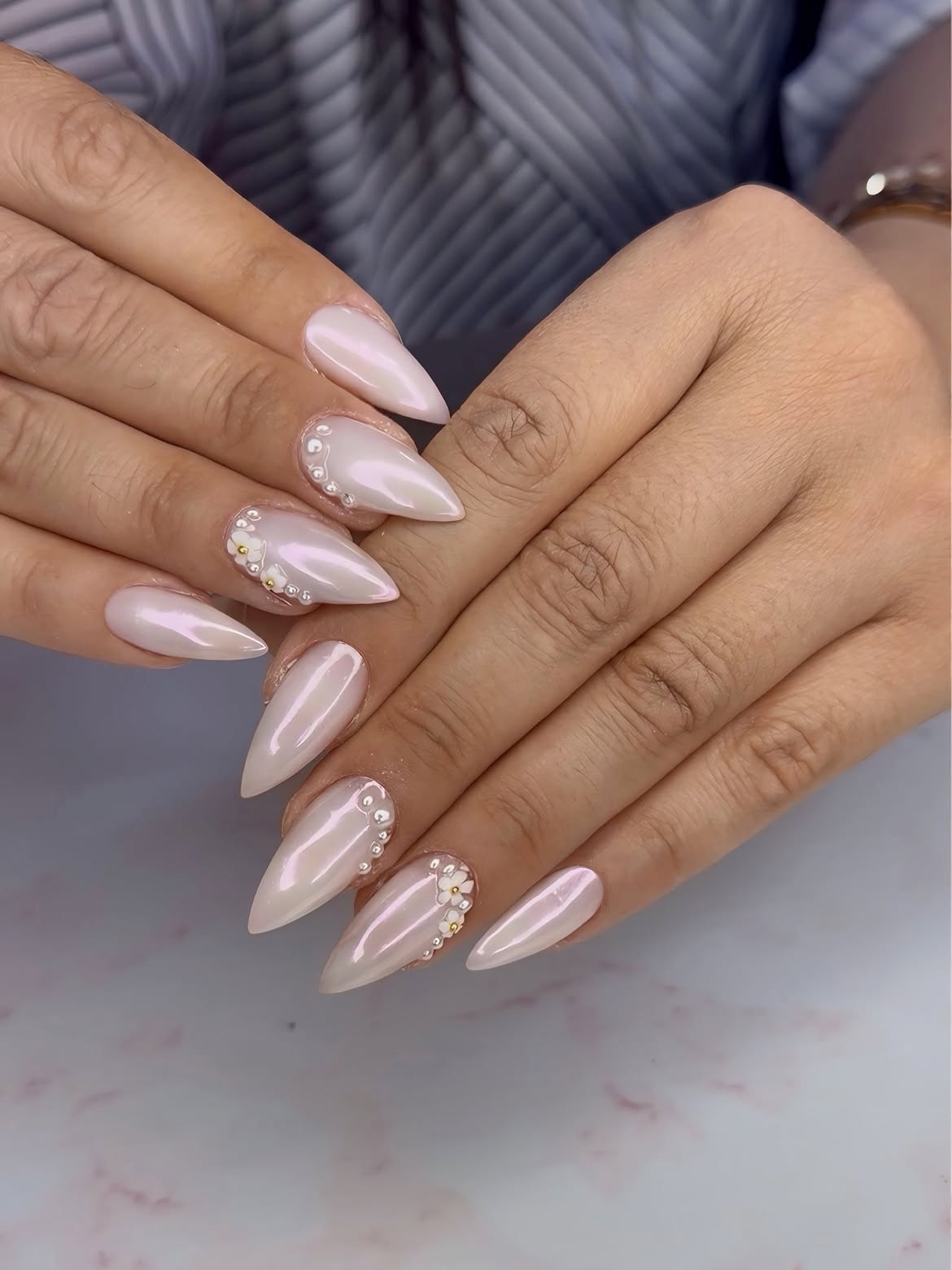 Pearlescent Stiletto Nails with Pearl and Flower Embellishments