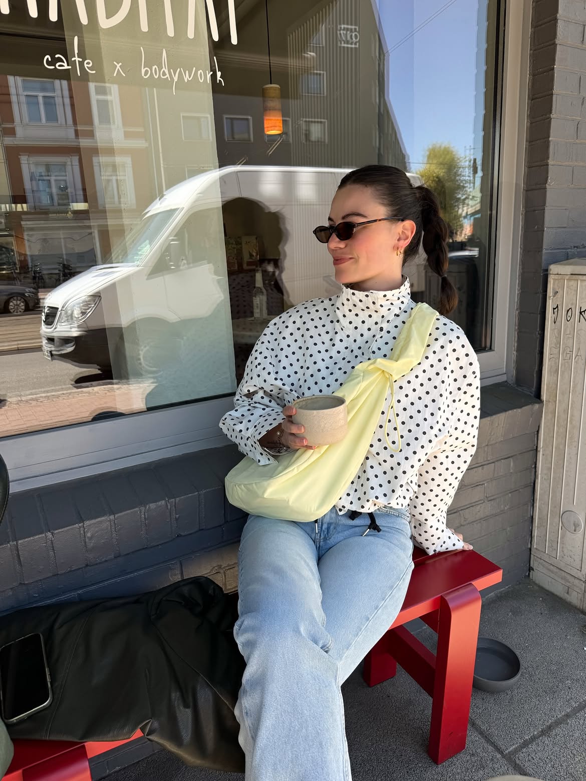 Polka Dot Top With Light Wash Denim And Pop Bag