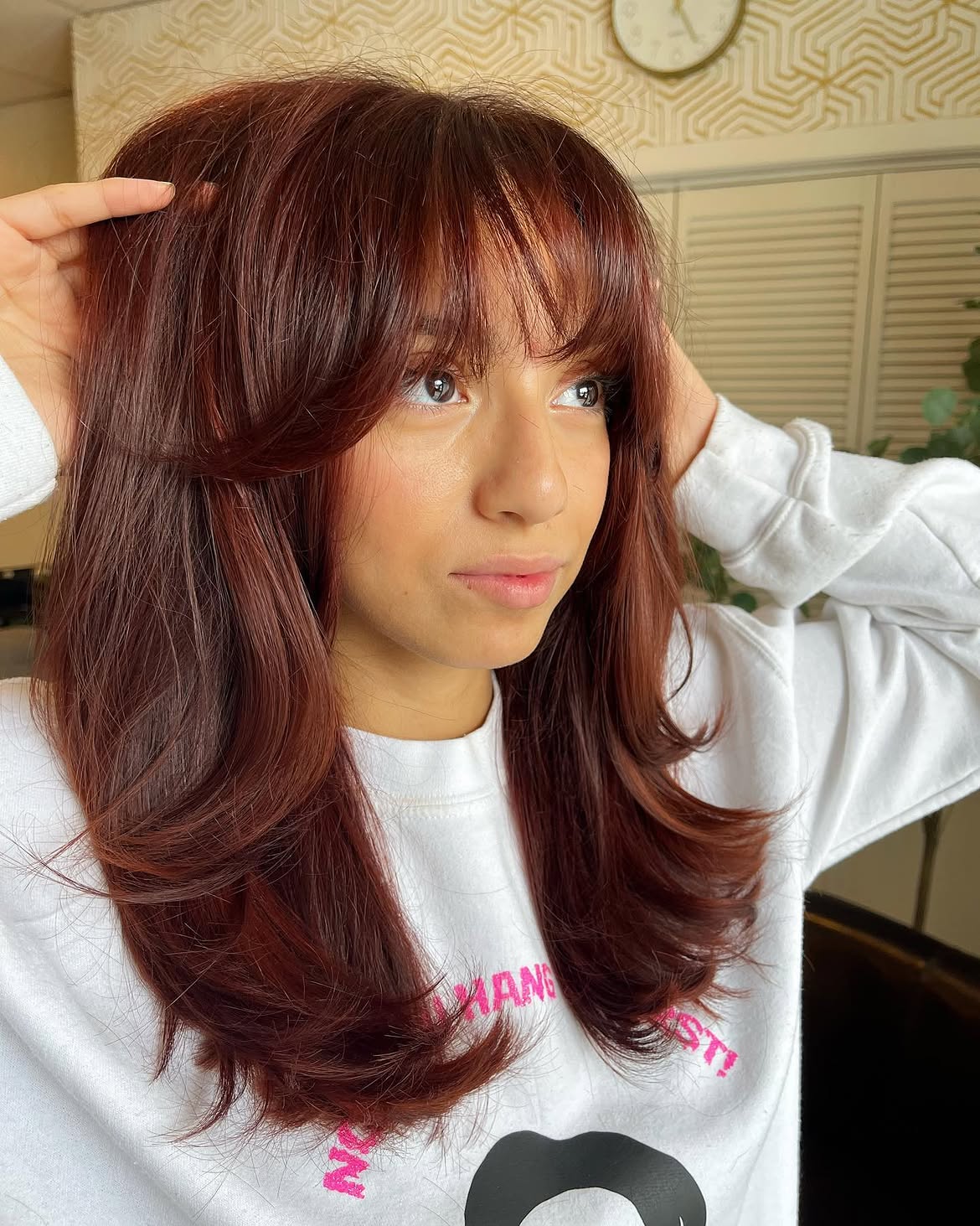 Rich Auburn Layers With Face-Framing Bangs