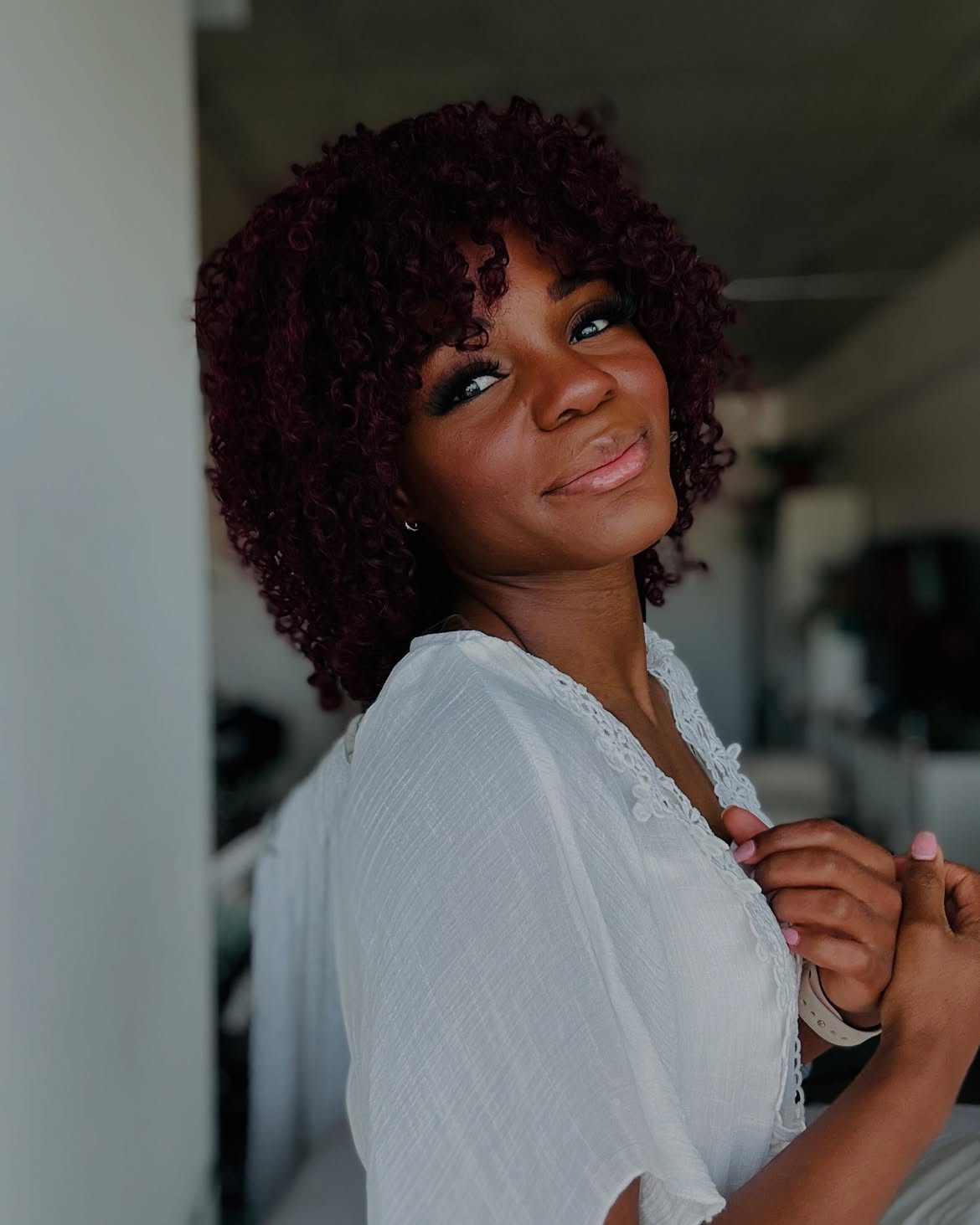 Rich Burgundy Curly Bob With Face-Framing Bangs
