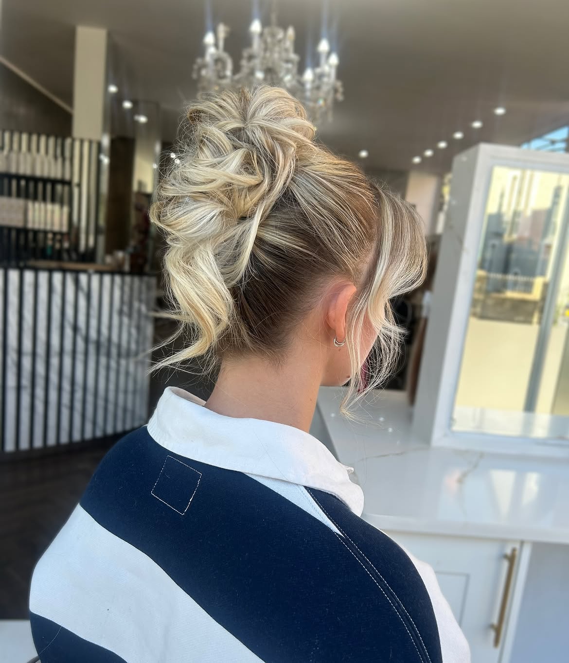Tousled Blonde Updo With Face-Framing Tendrils