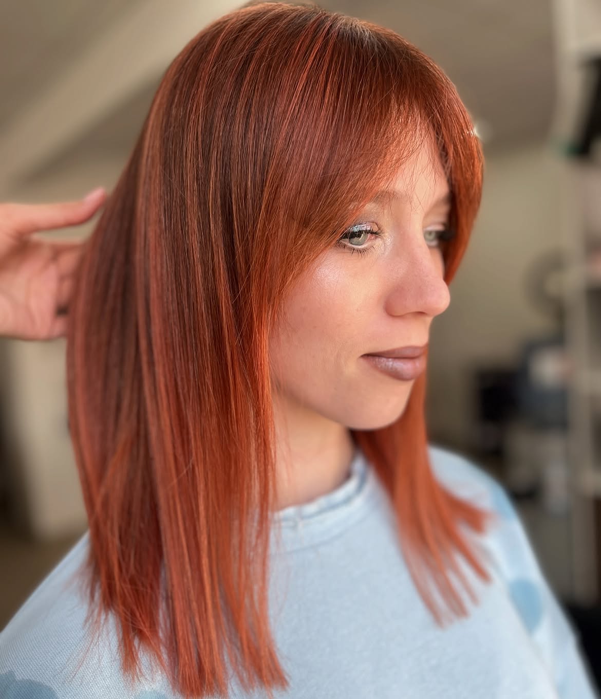Vibrant Copper Highlights With Face-Framing Bangs