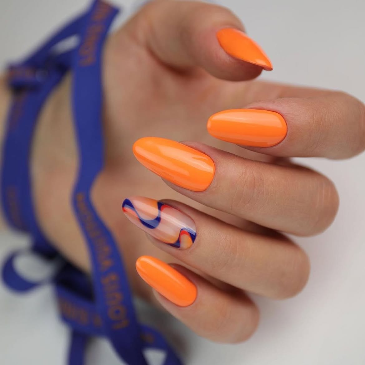 Vibrant Orange Abstract Swirl Almond Nails