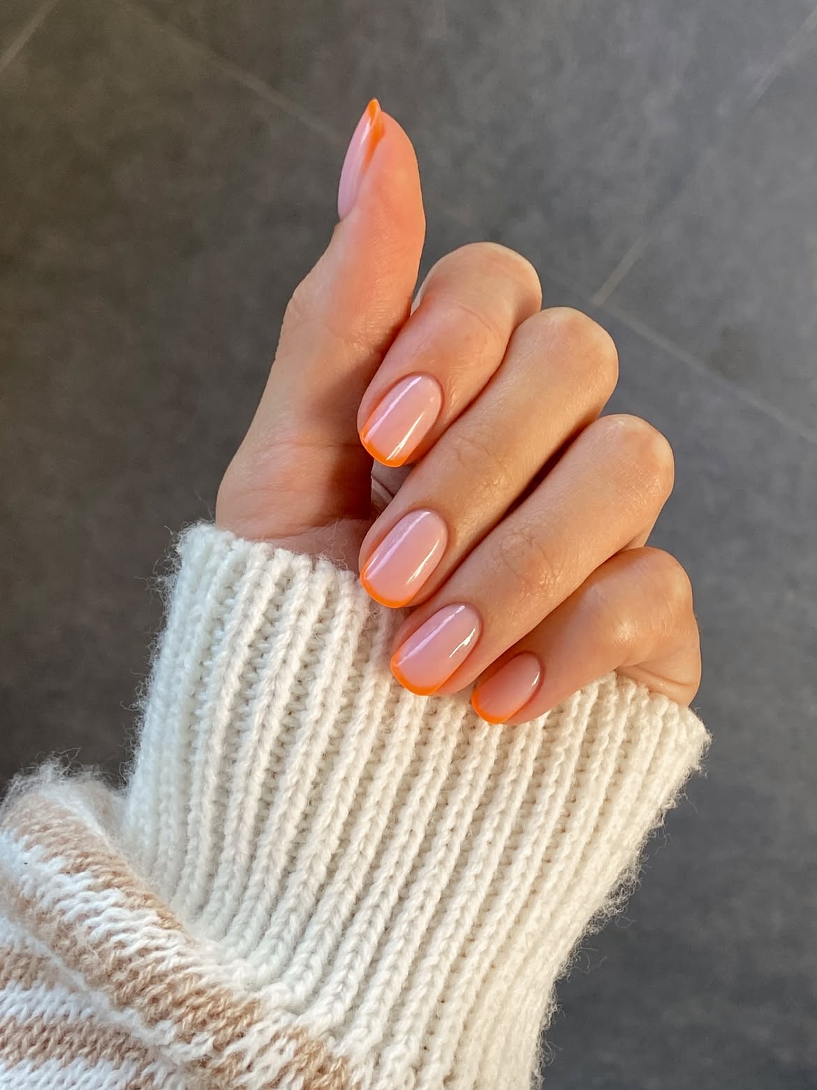 Vibrant Orange Tip Milky French Nails