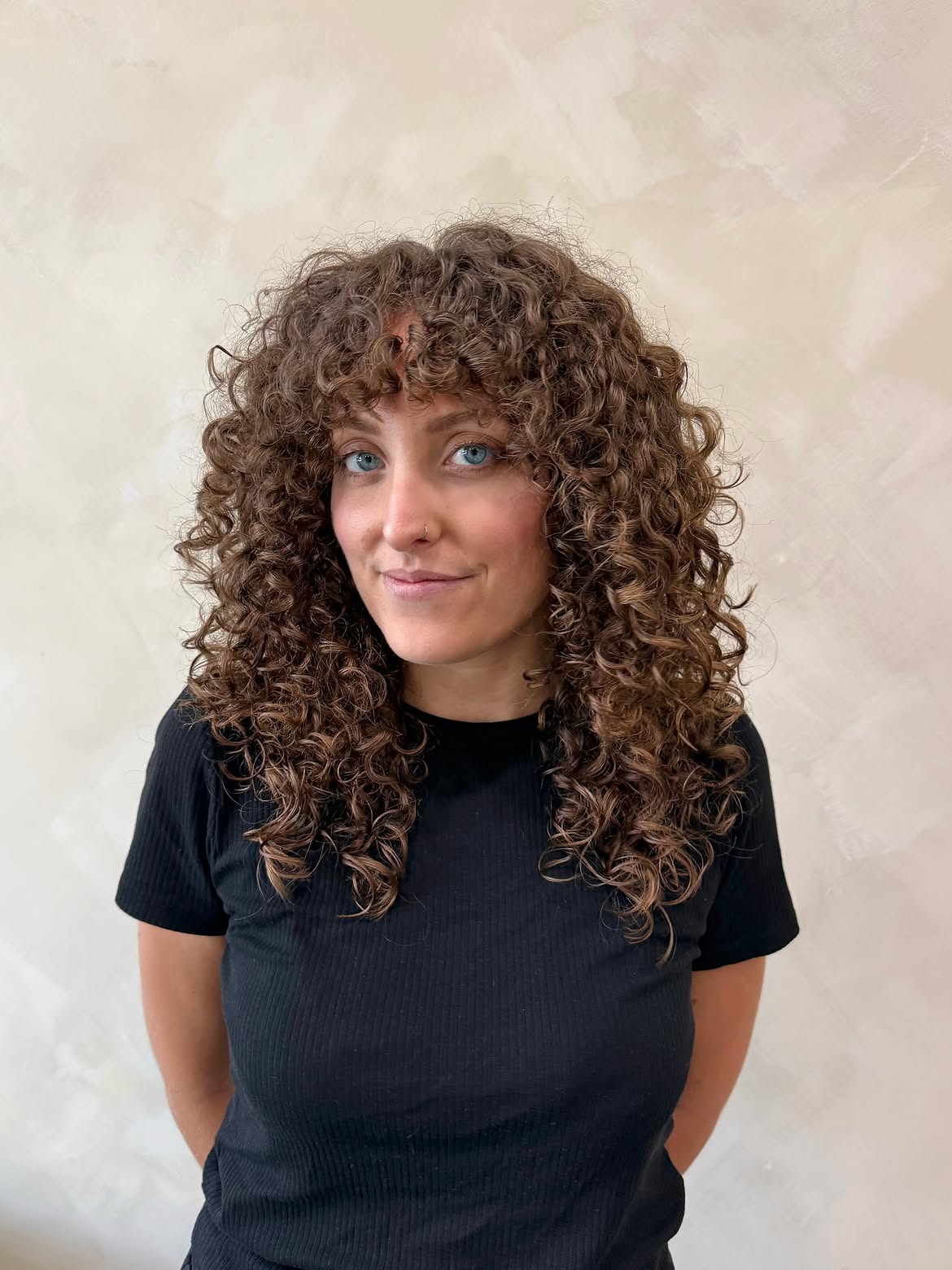 Bold Curly Bangs With Textured Brunette Layers