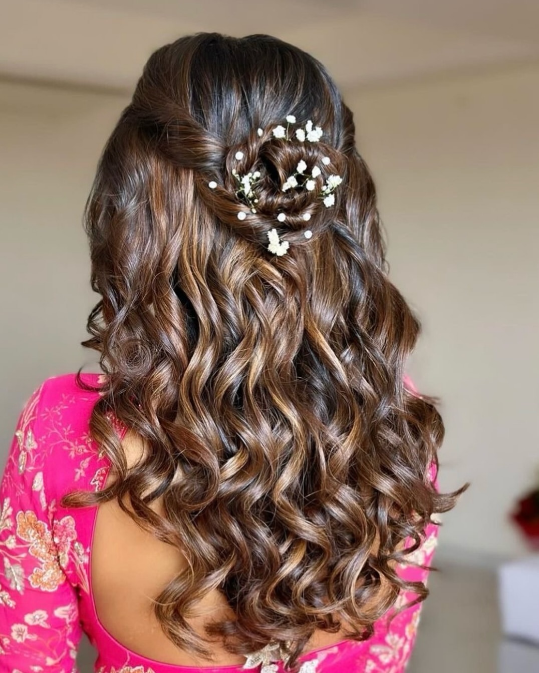 Cascading Curls With Floral Hairpiece Accent