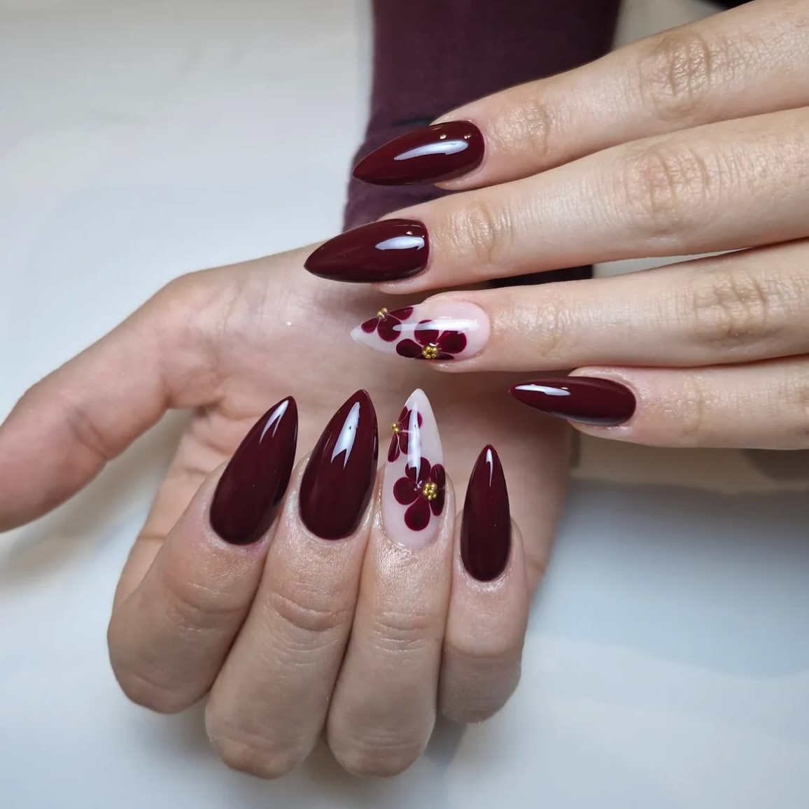 Deep Burgundy Stiletto Nails with Floral Accents