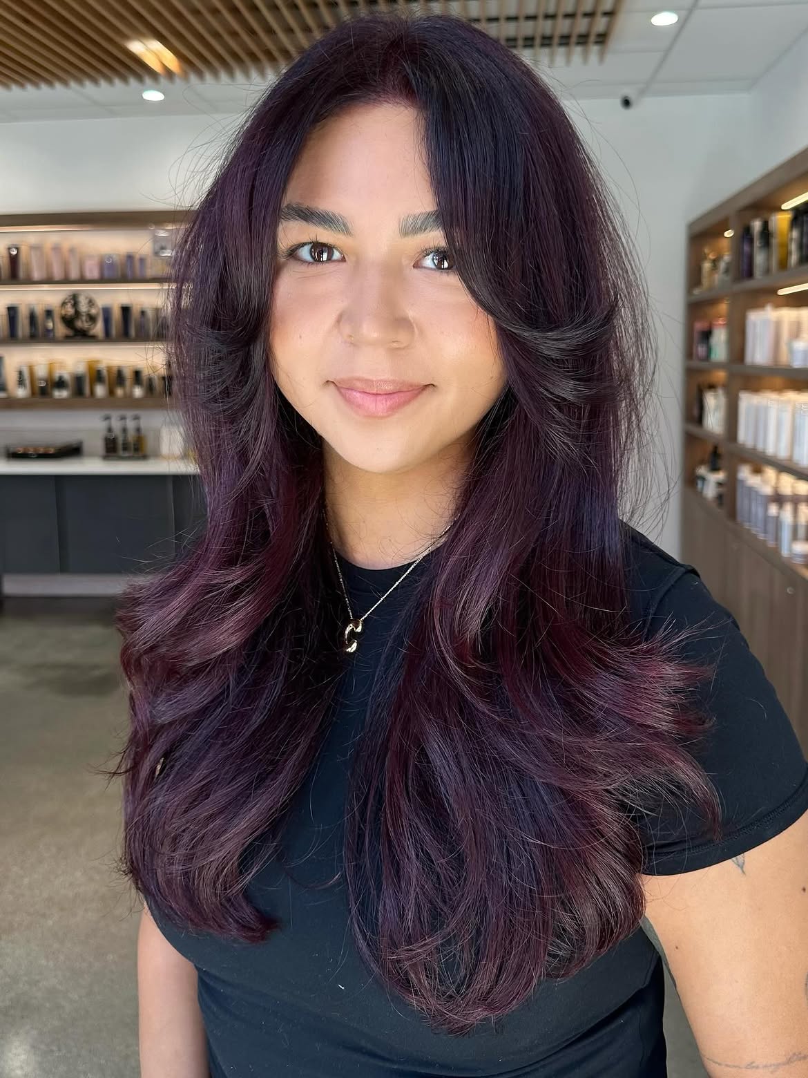 Deep Plum Layers With Voluminous Curtain Bangs