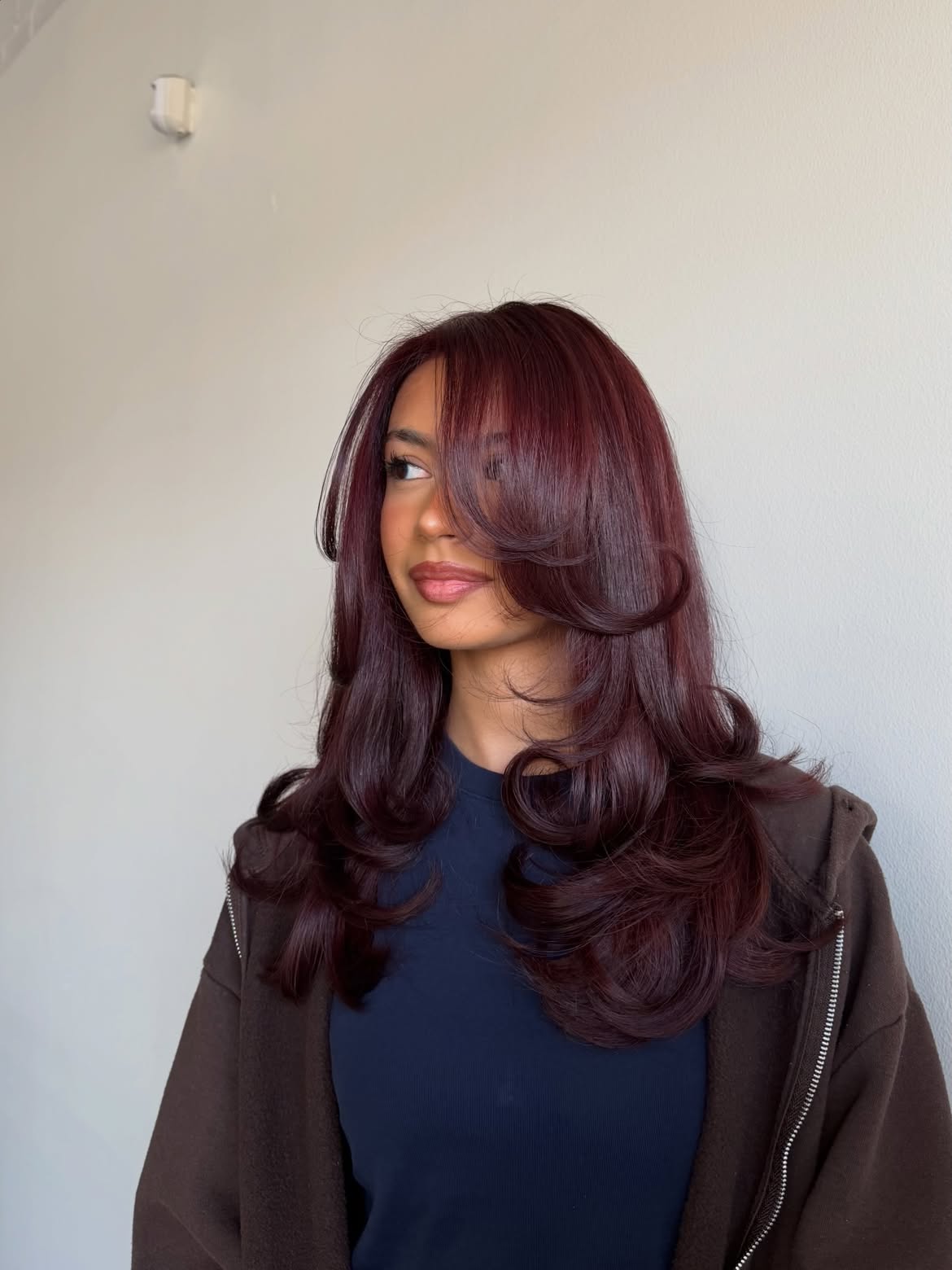 Deep Plum Layers With Voluminous Face Framing