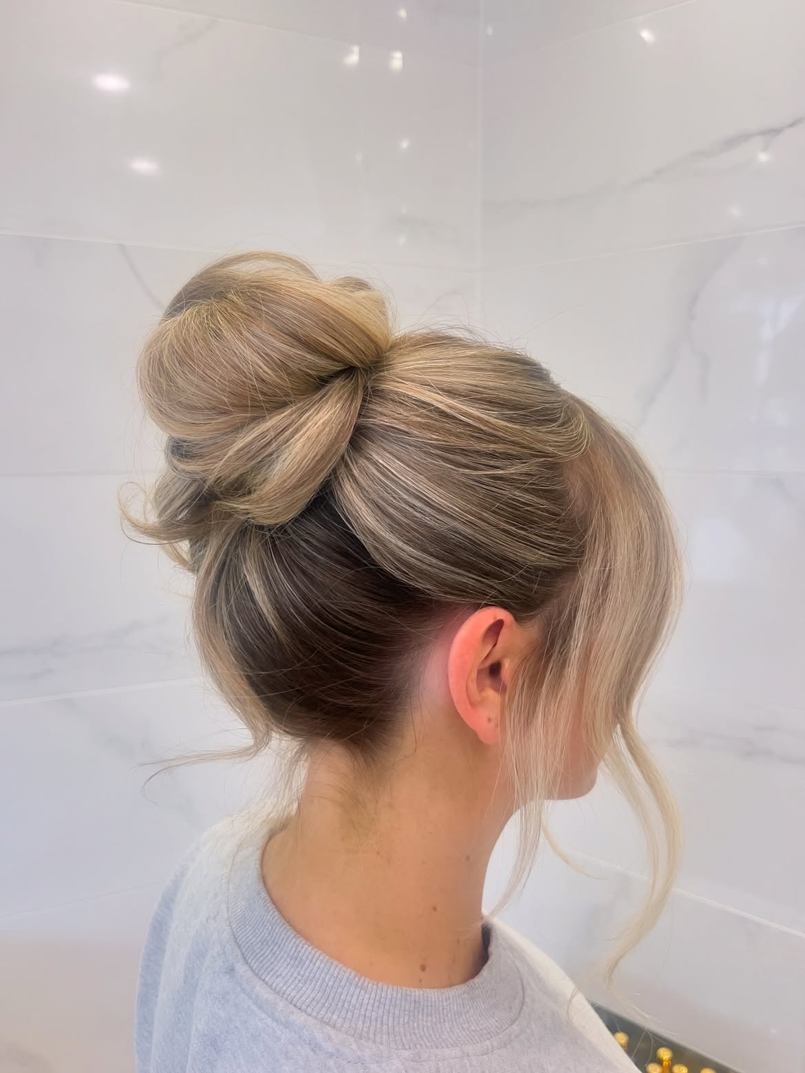 Effortless Chic High Twisted Bun With Face Framing Strands