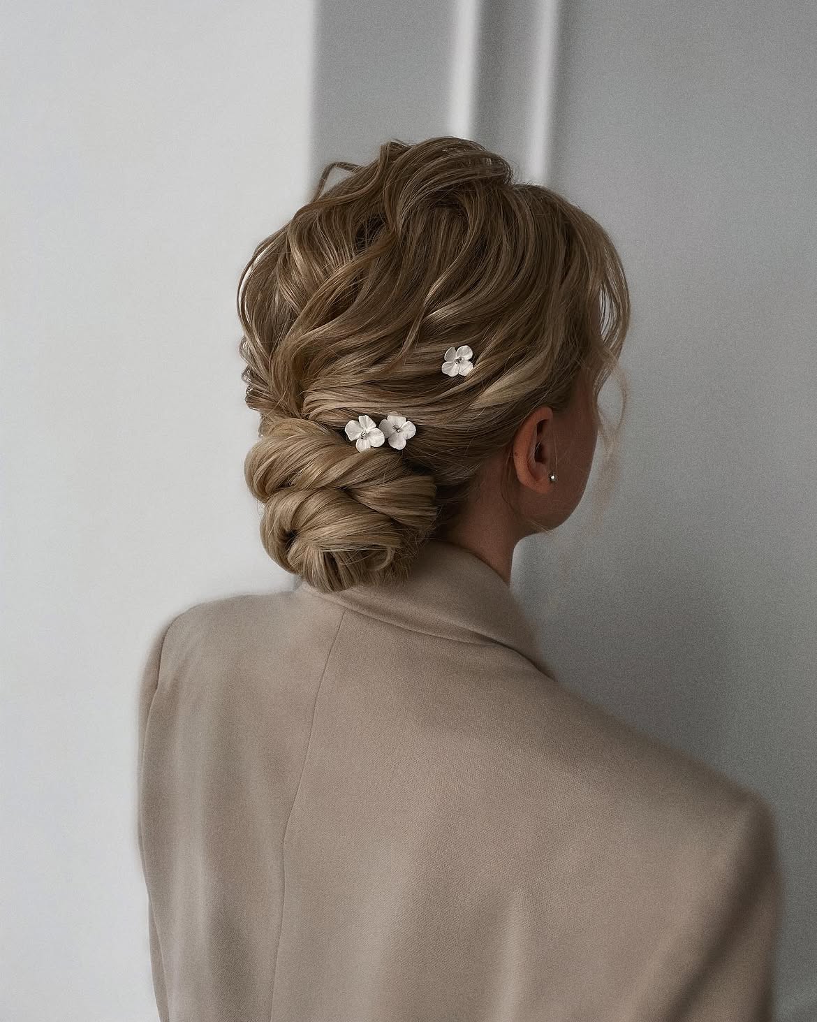 Elegant Braided Updo With Delicate Floral Accents