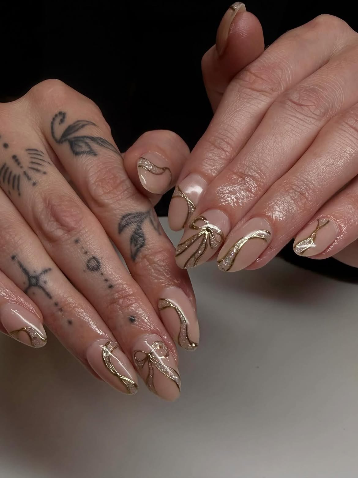 Elegant Gold Bow Aura Almond Nails