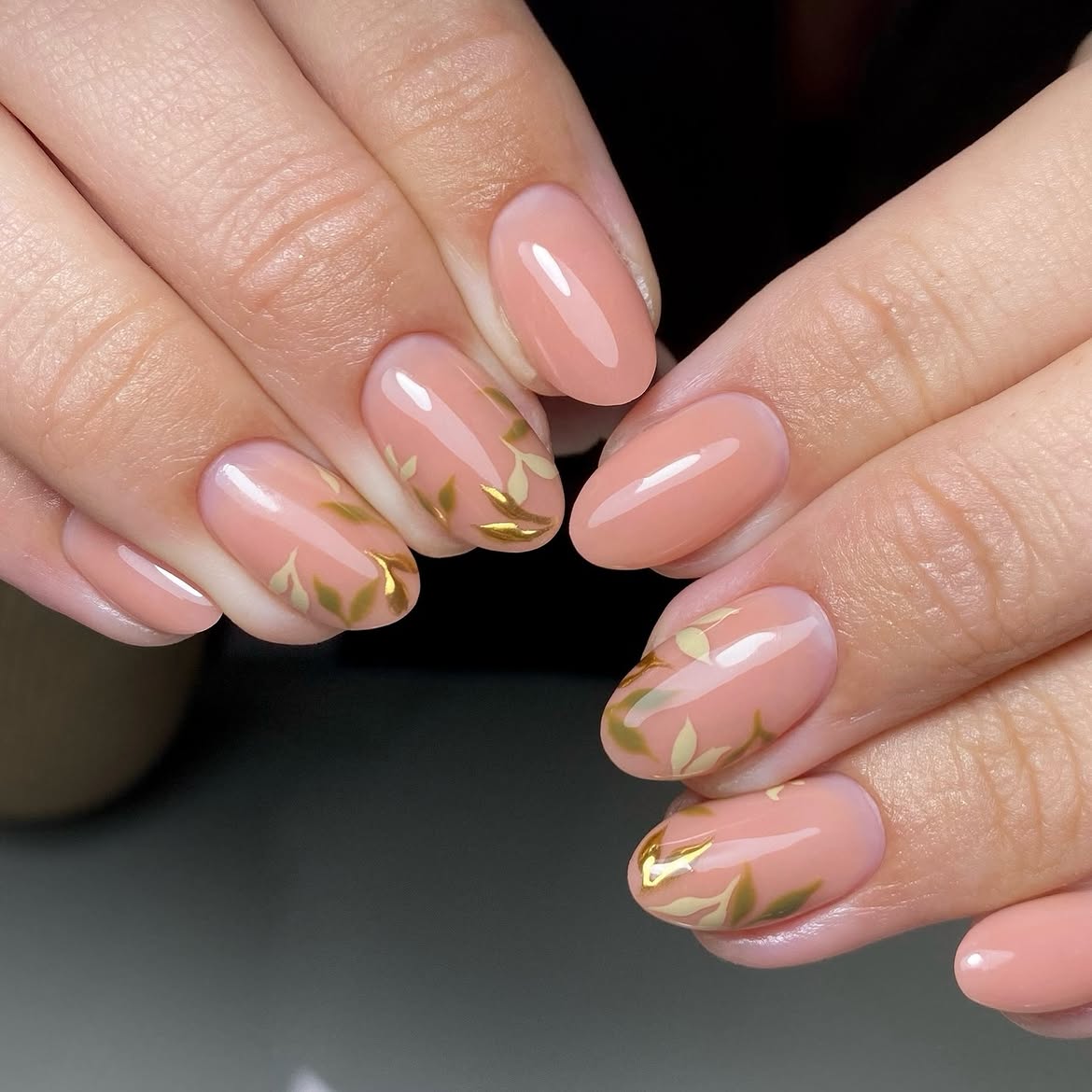 Elegant Peach Aura Nails With Gold Leaf Accents
