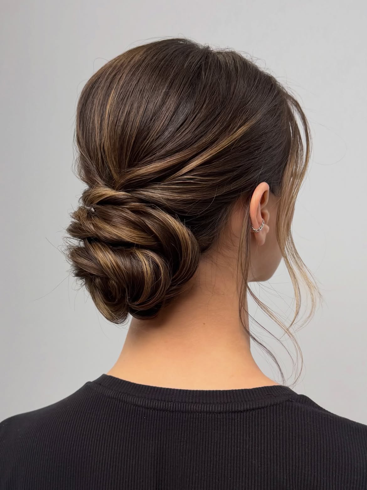 Elegant Twisted Low Bun With Caramel Highlights