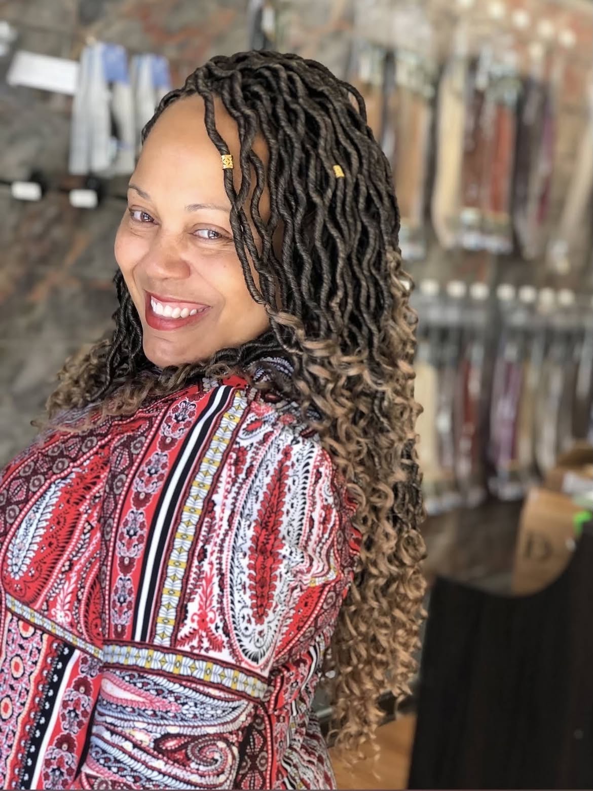 Faux Locs With Curly Ends and Gold Accents