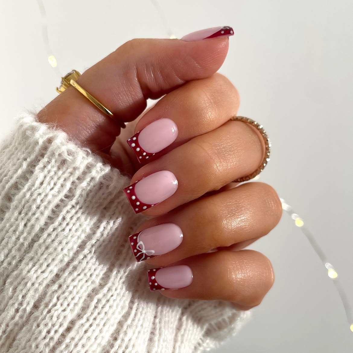 Festive Polka Dot French Tip Nails with Bow Accent