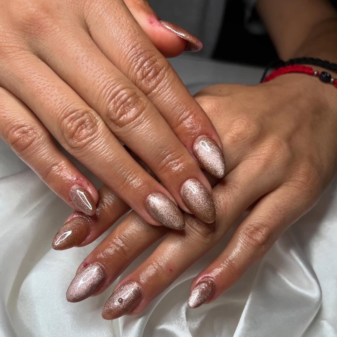Glimmering Rose Gold Cat Eye Almond Nails