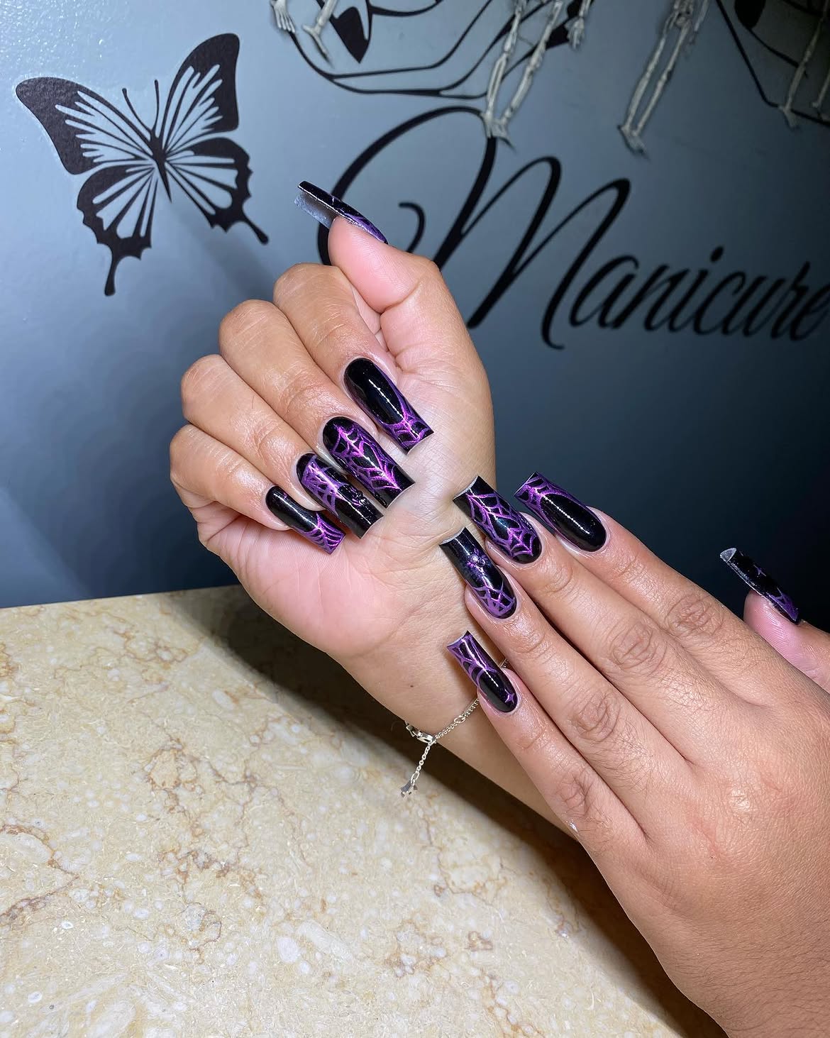 Glossy Black Coffin Nails with Purple Web Design