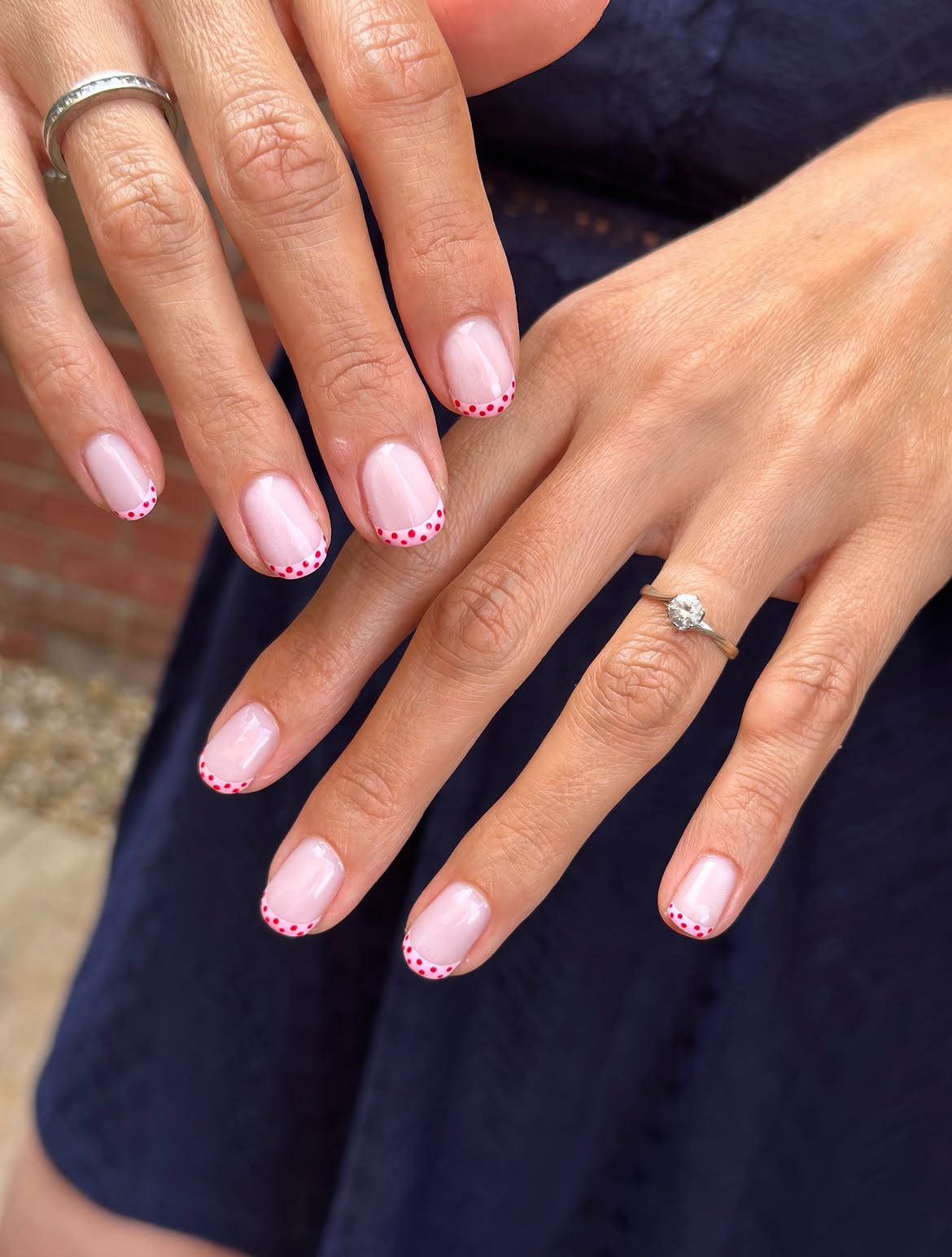 Glossy Nude Nails With Red Polka Dot Tips